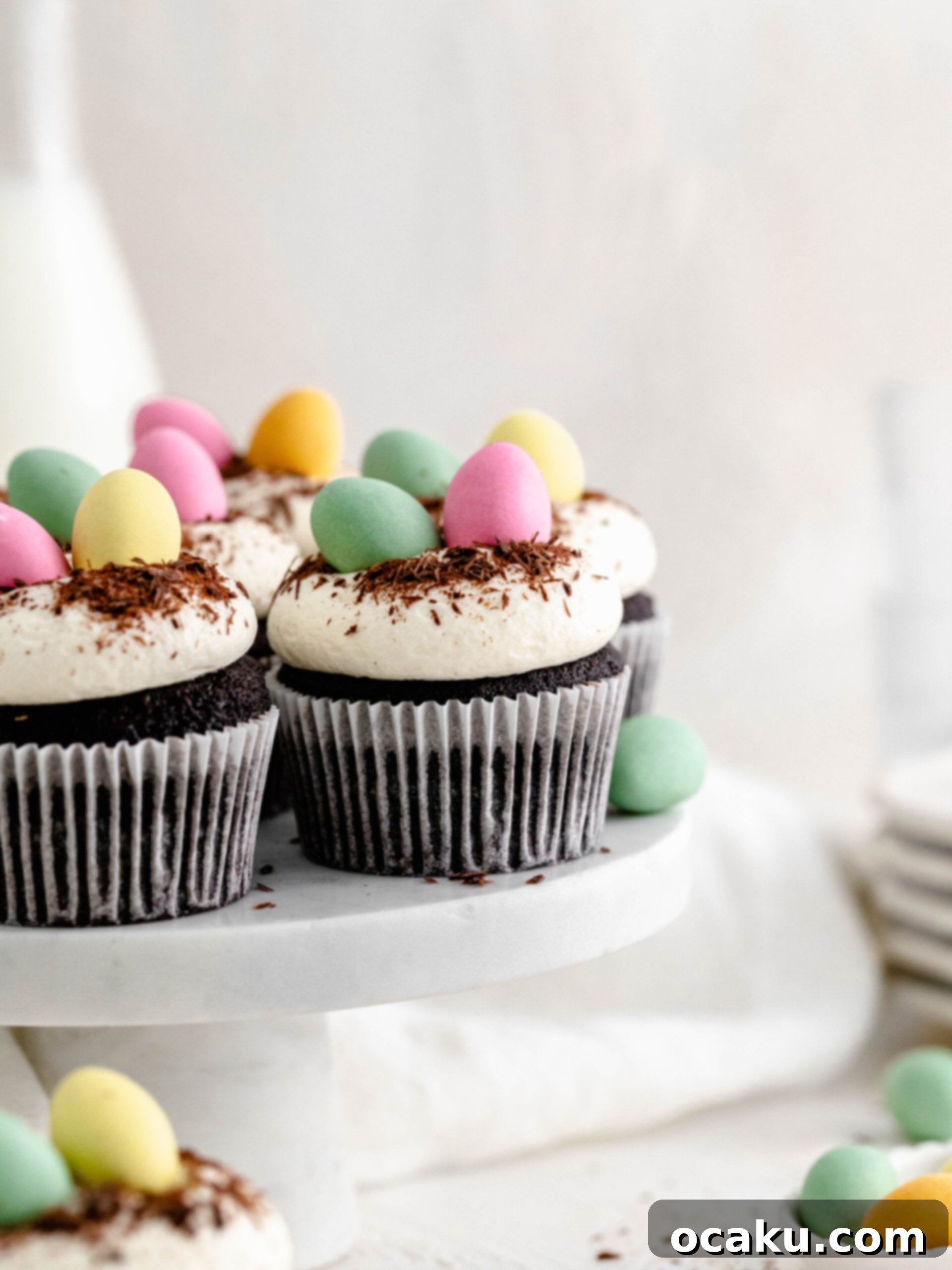 Easter Mini Egg Cupcakes 2 Delicious mini egg chocolate cupcakes with cream cheese frosting and a hidden Easter egg, displayed on a beautiful cake stand.