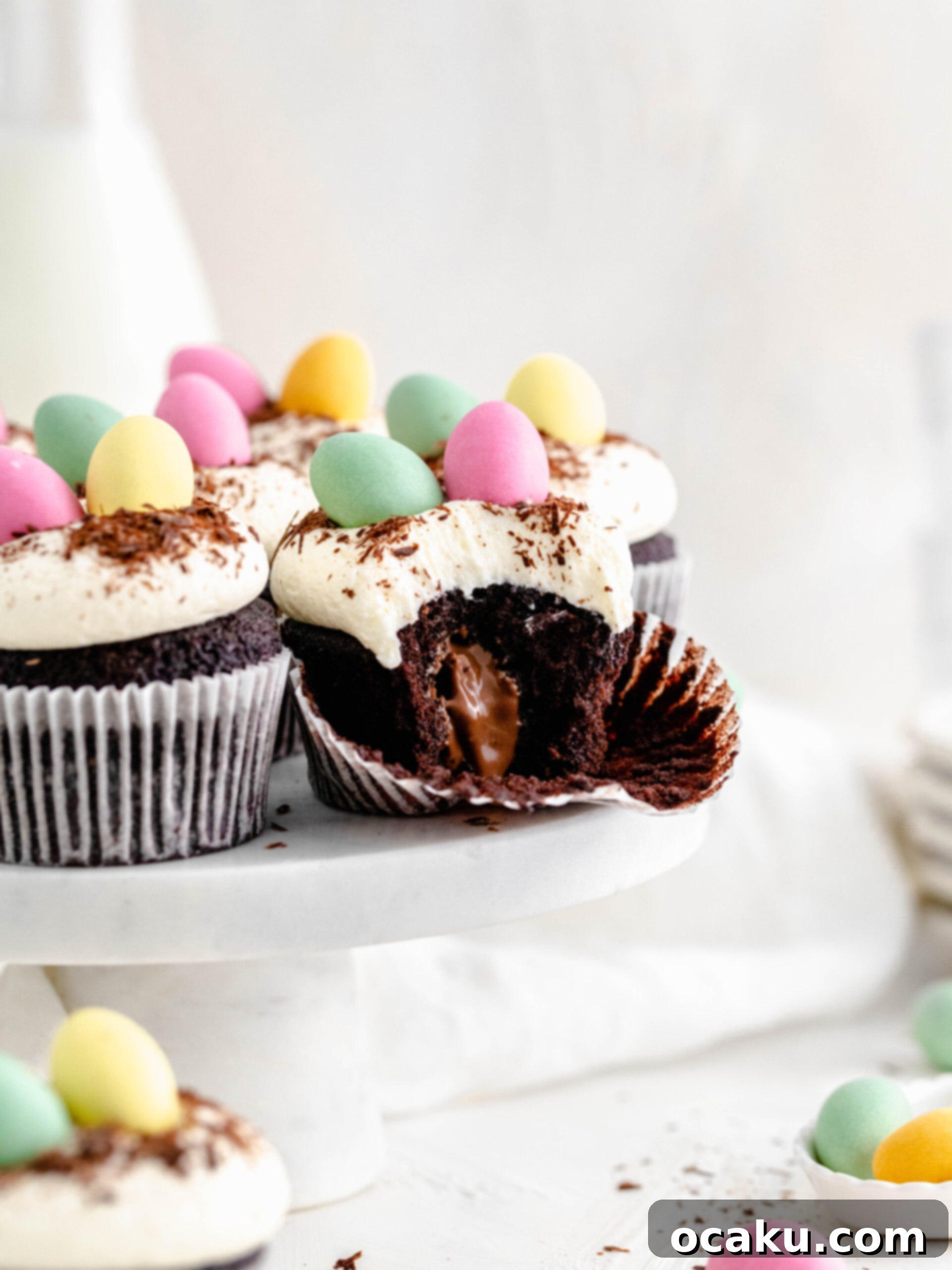 Mini Egg Cupcakes Close-up of freshly baked mini egg cupcakes, showcasing their soft chocolate crumb and vibrant cream cheese frosting.