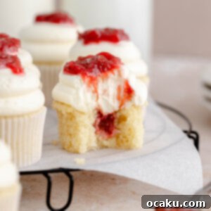 A top-down view of a beautifully decorated rhubarb and almond cupcake.