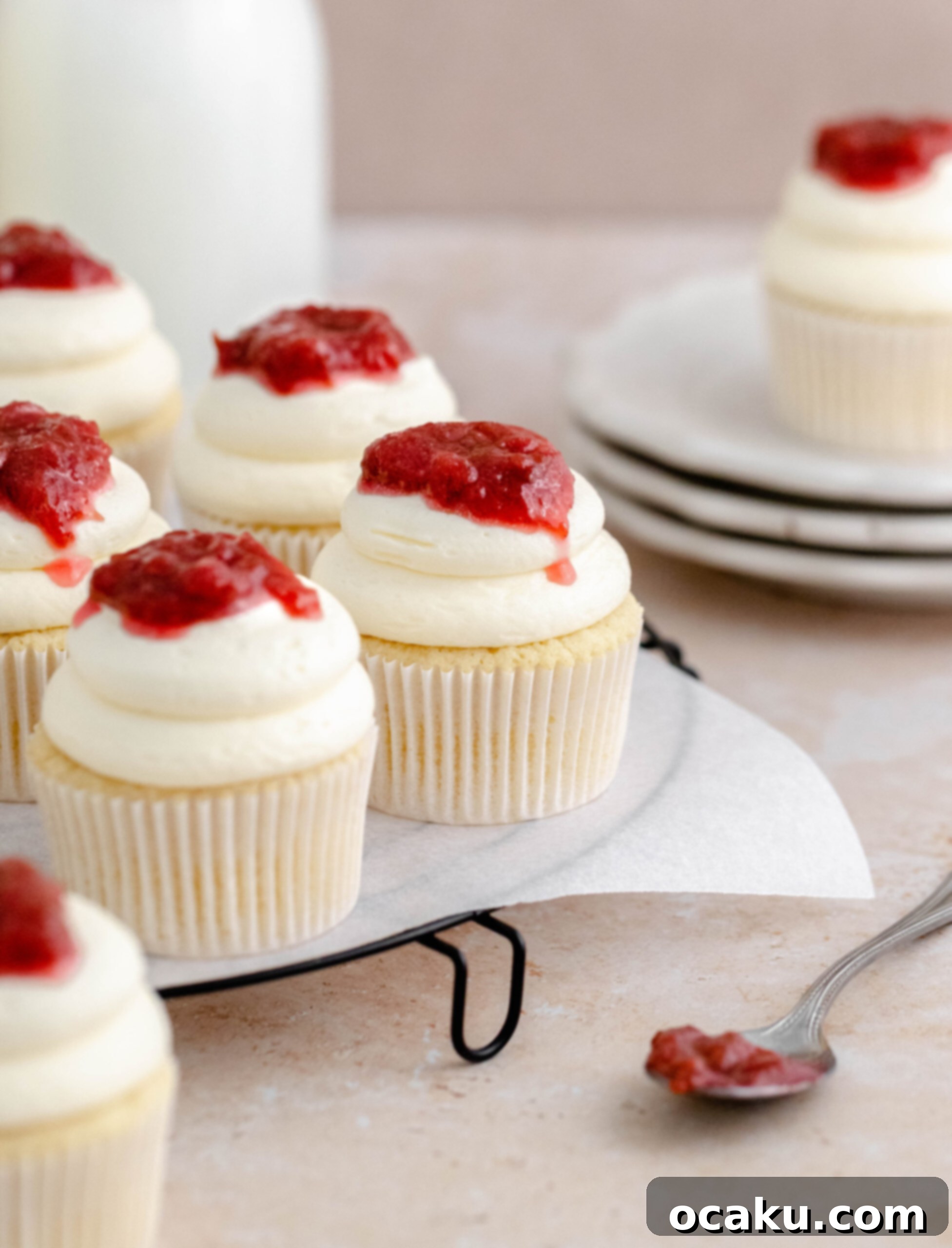 A tray filled with multiple rhubarb and almond cupcakes, ready for serving.