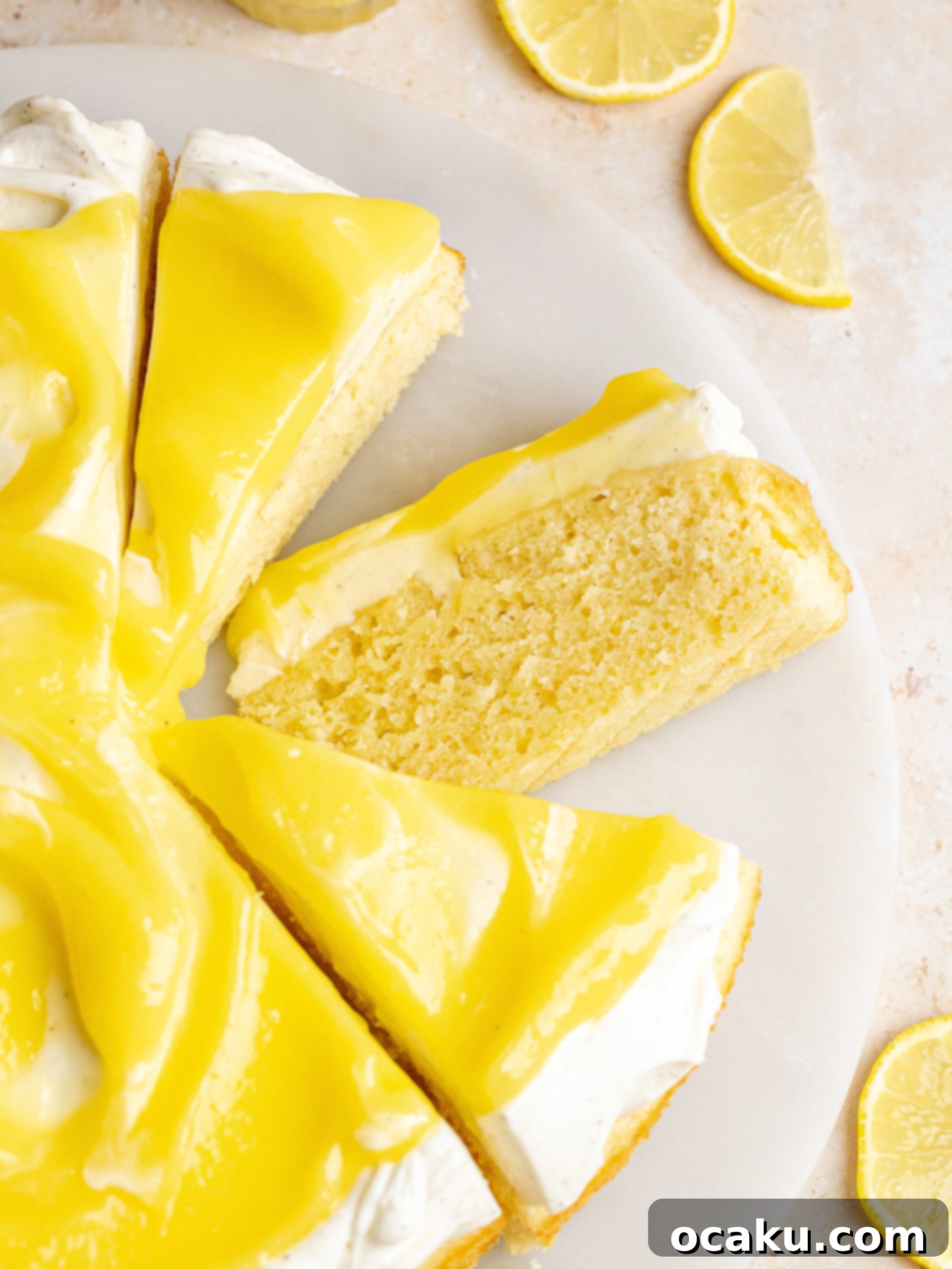 Lemon Curd Cake slice showing cake layers, mascarpone frosting, and lemon curd
