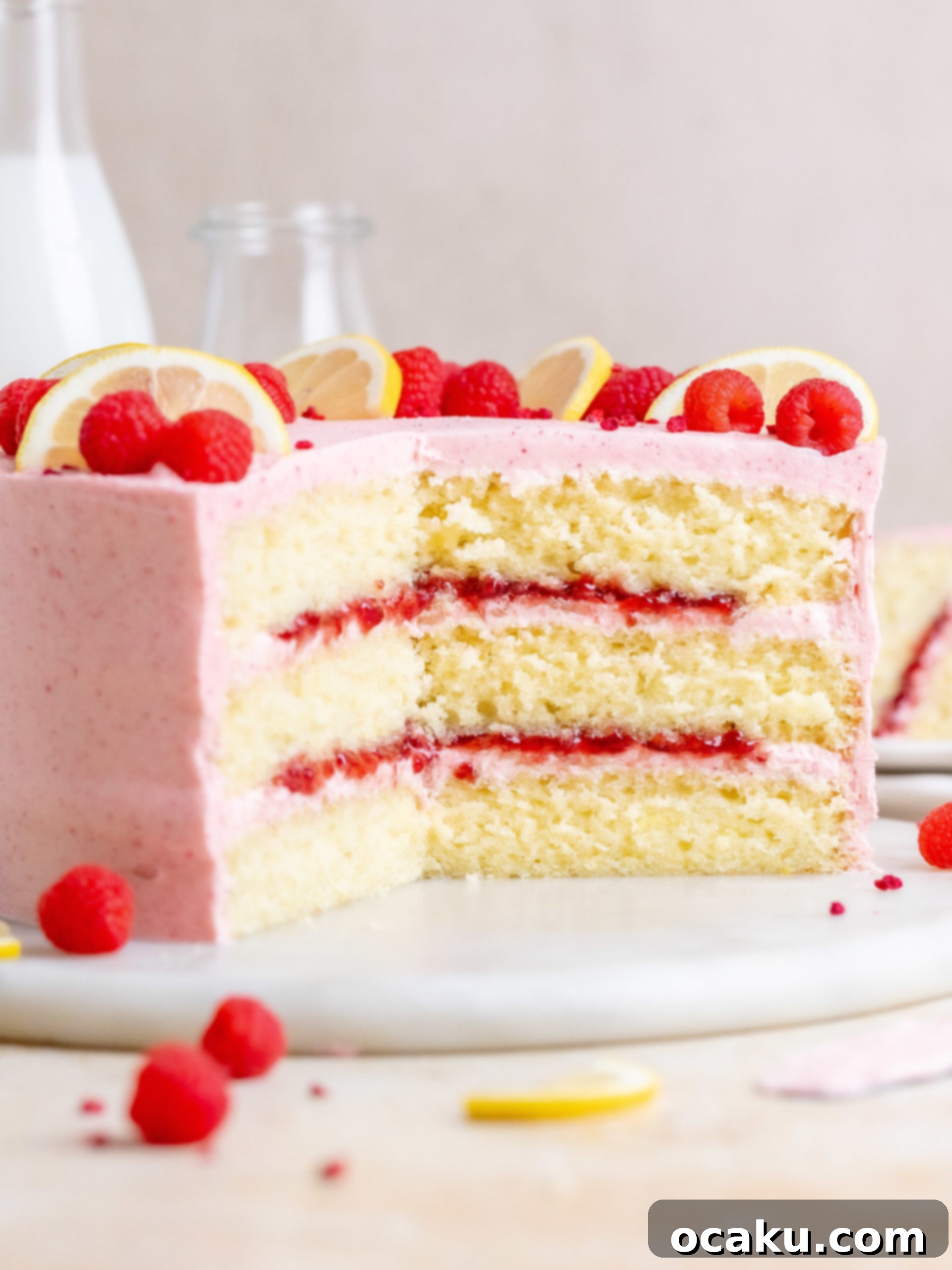 Slice of Lemon Raspberry Cake with pink buttercream and raspberry jam