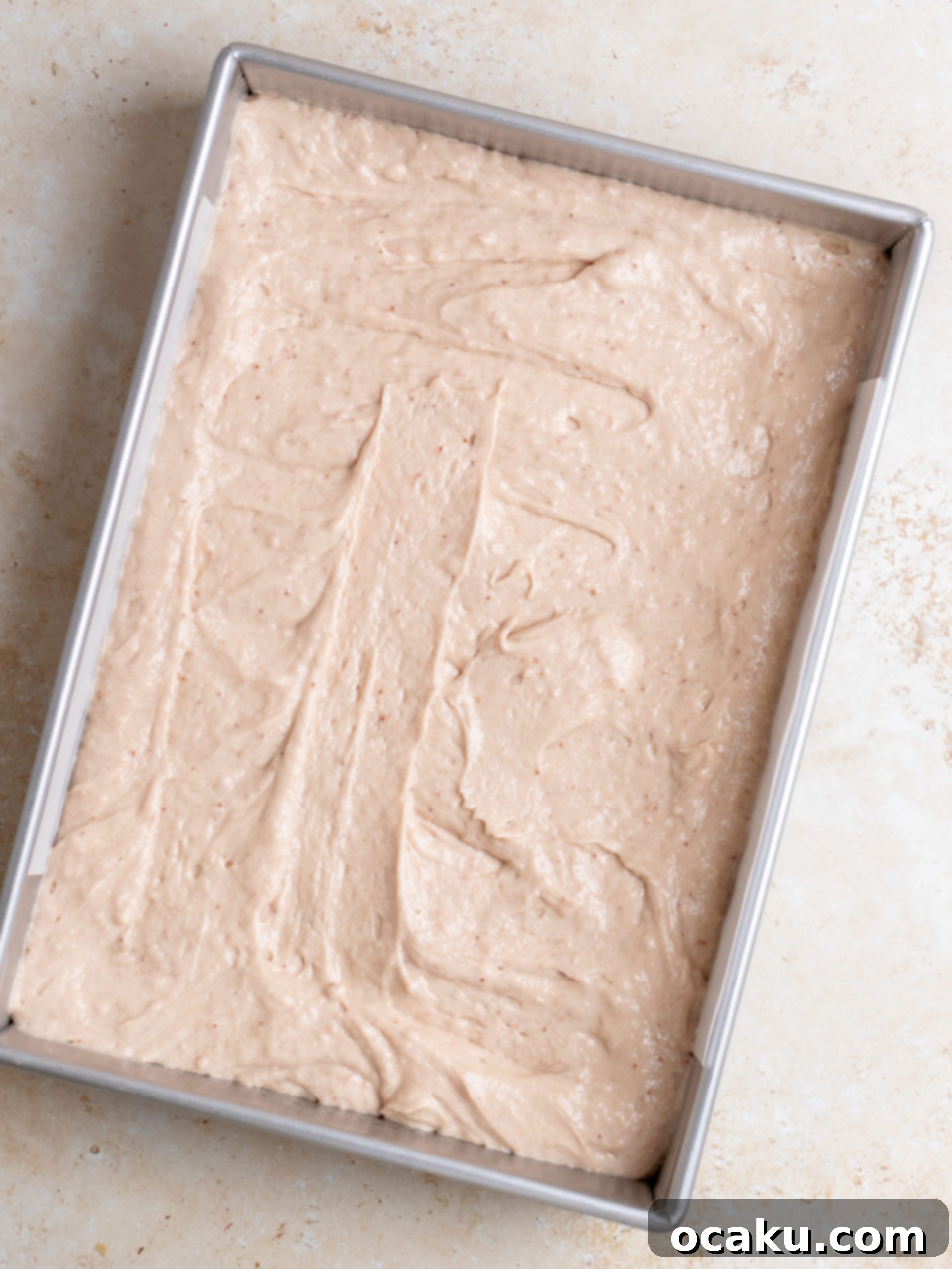 Smooth strawberry cream cheese frosting in a mixing bowl.