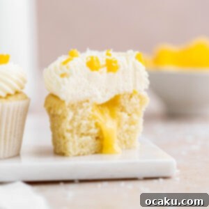 Mango Bliss Cupcakes 7 Soft coconut cupcake, filled with a delicious mango curd and topped with a smooth coconut and vanilla buttercream