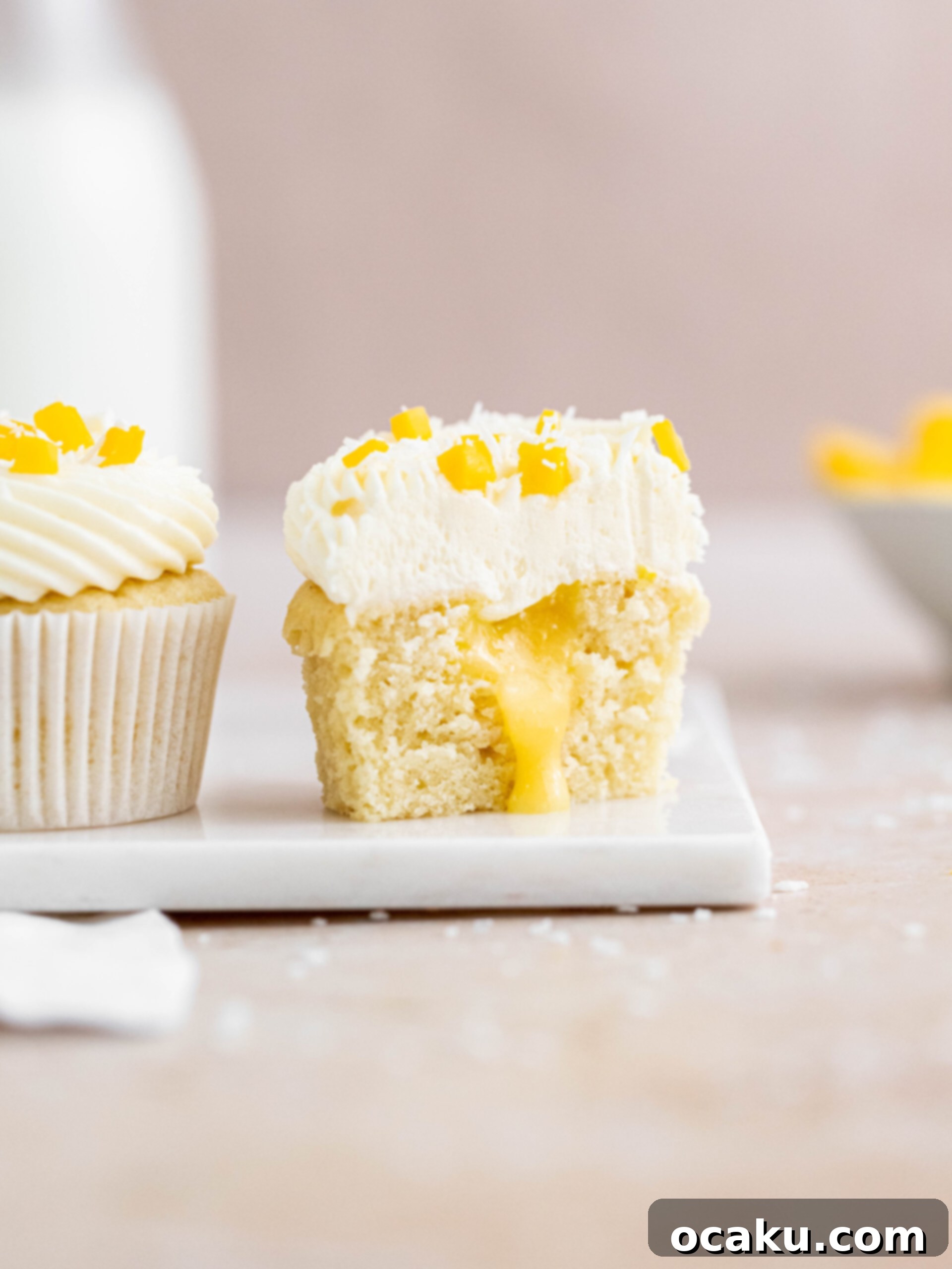 Aperol Spritz Cheesecake Soft coconut cupcake, cut in half to reveal the luscious mango curd filling, topped with smooth coconut buttercream and a sprinkle of fresh mango.