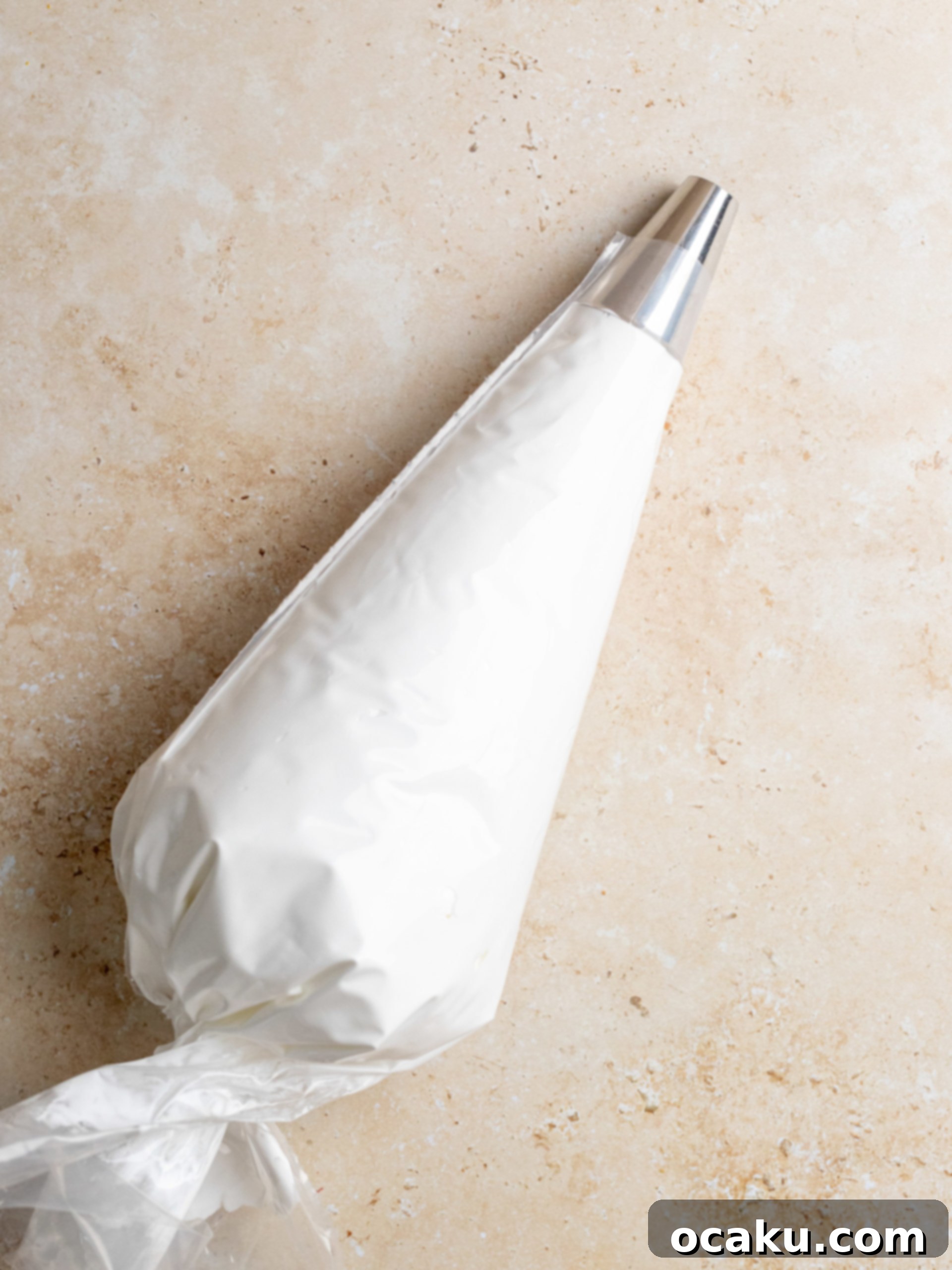 Meringue mixture being transferred into a piping bag with a large round tip