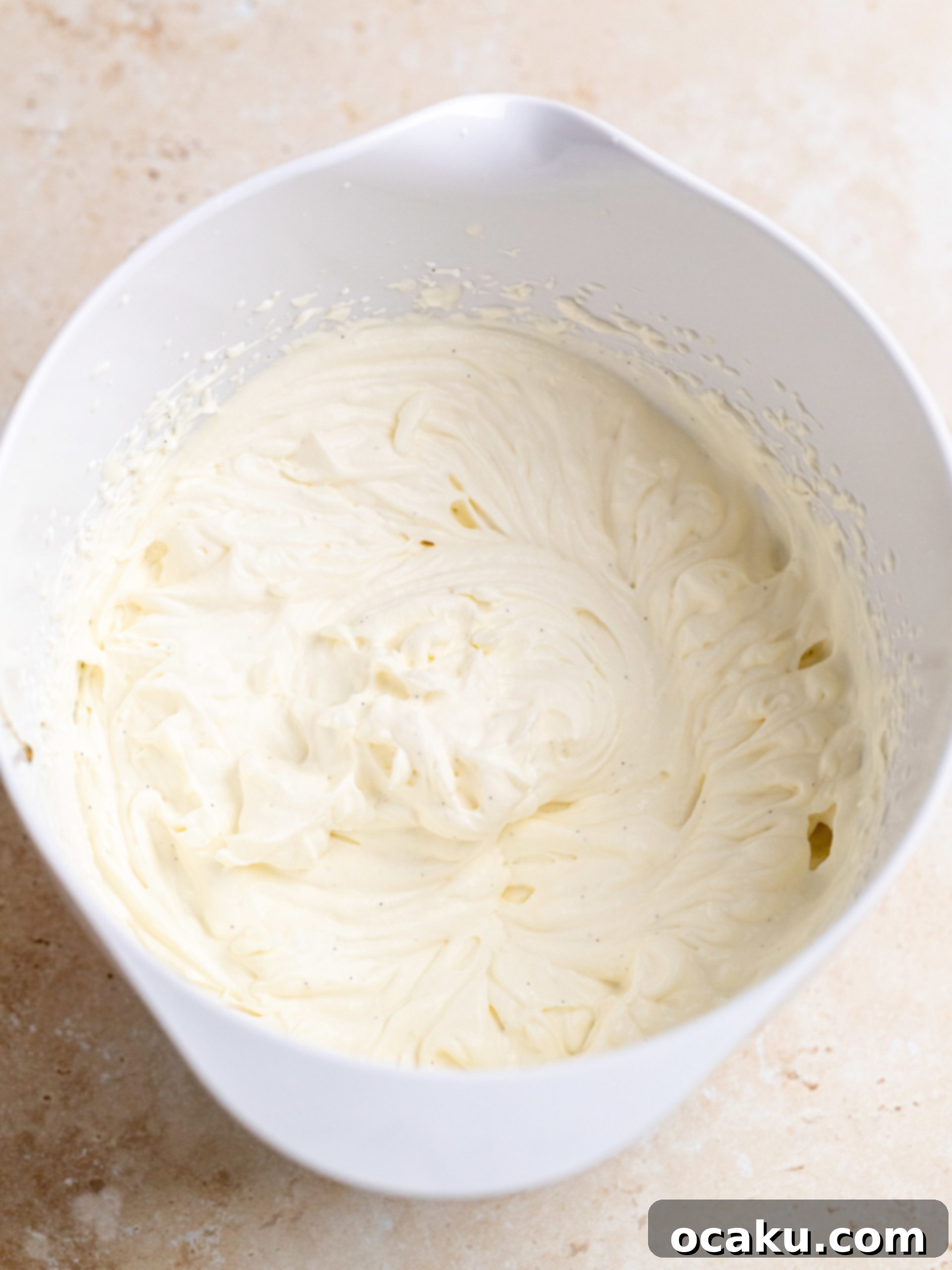 Assembled Summer Pavlova topped with fresh strawberries, kiwi, and mint leaves, ready to be served