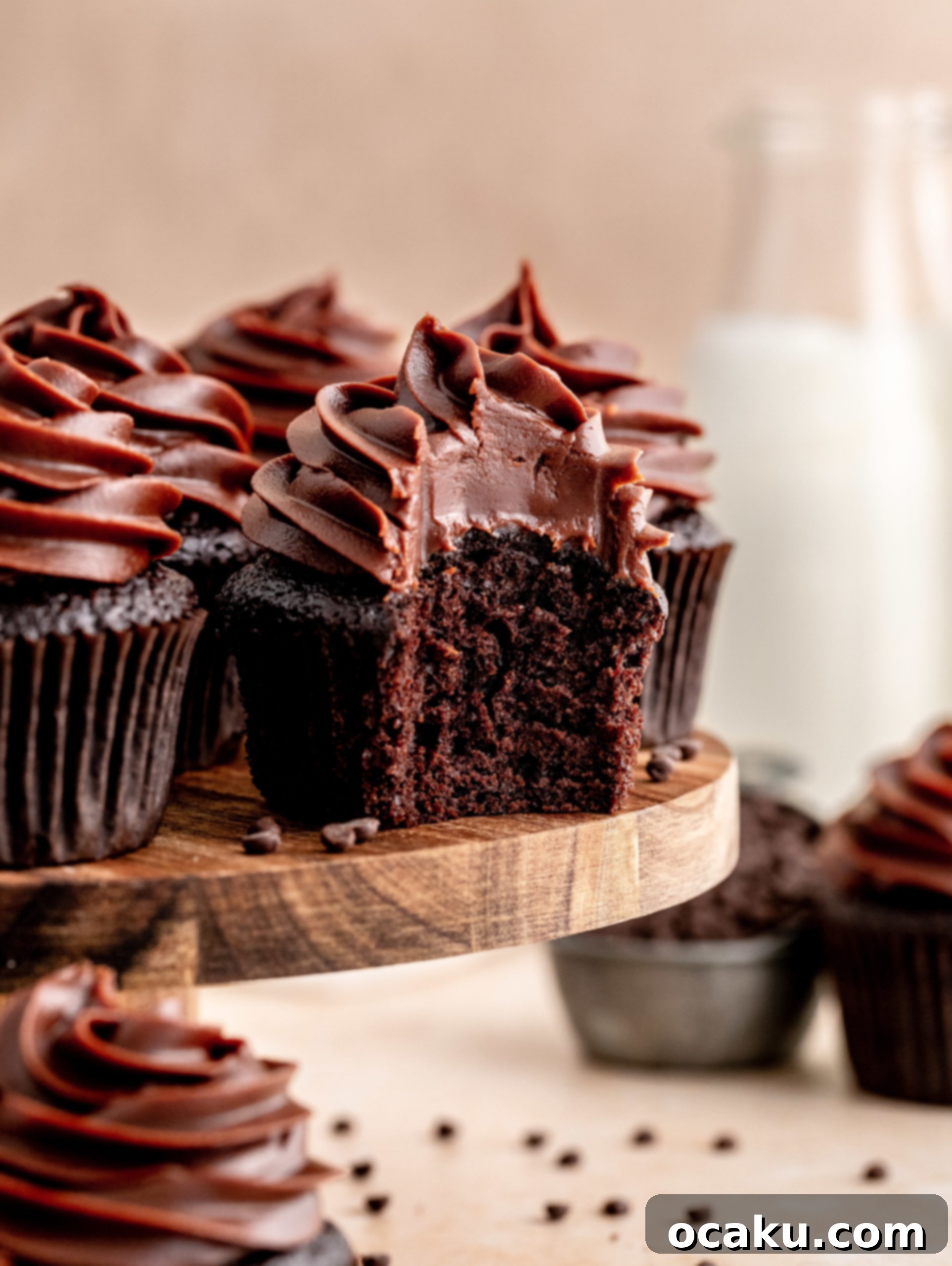 A bite taken of a chocolate Fudge Cupcakes, showing the moist cake.