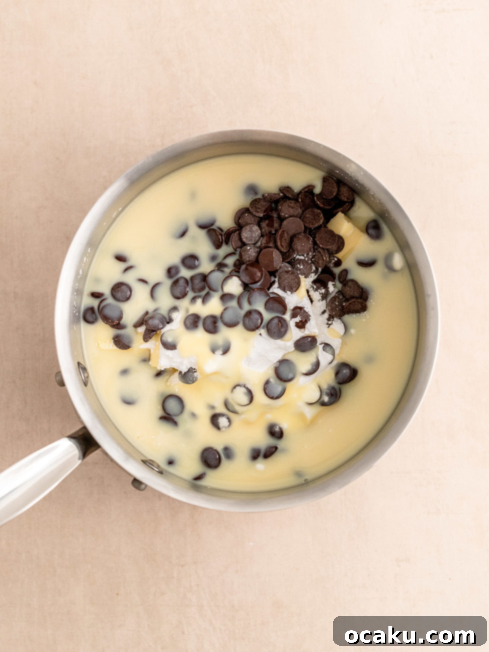Melting chocolate, butter, and condensed milk for fudge frosting