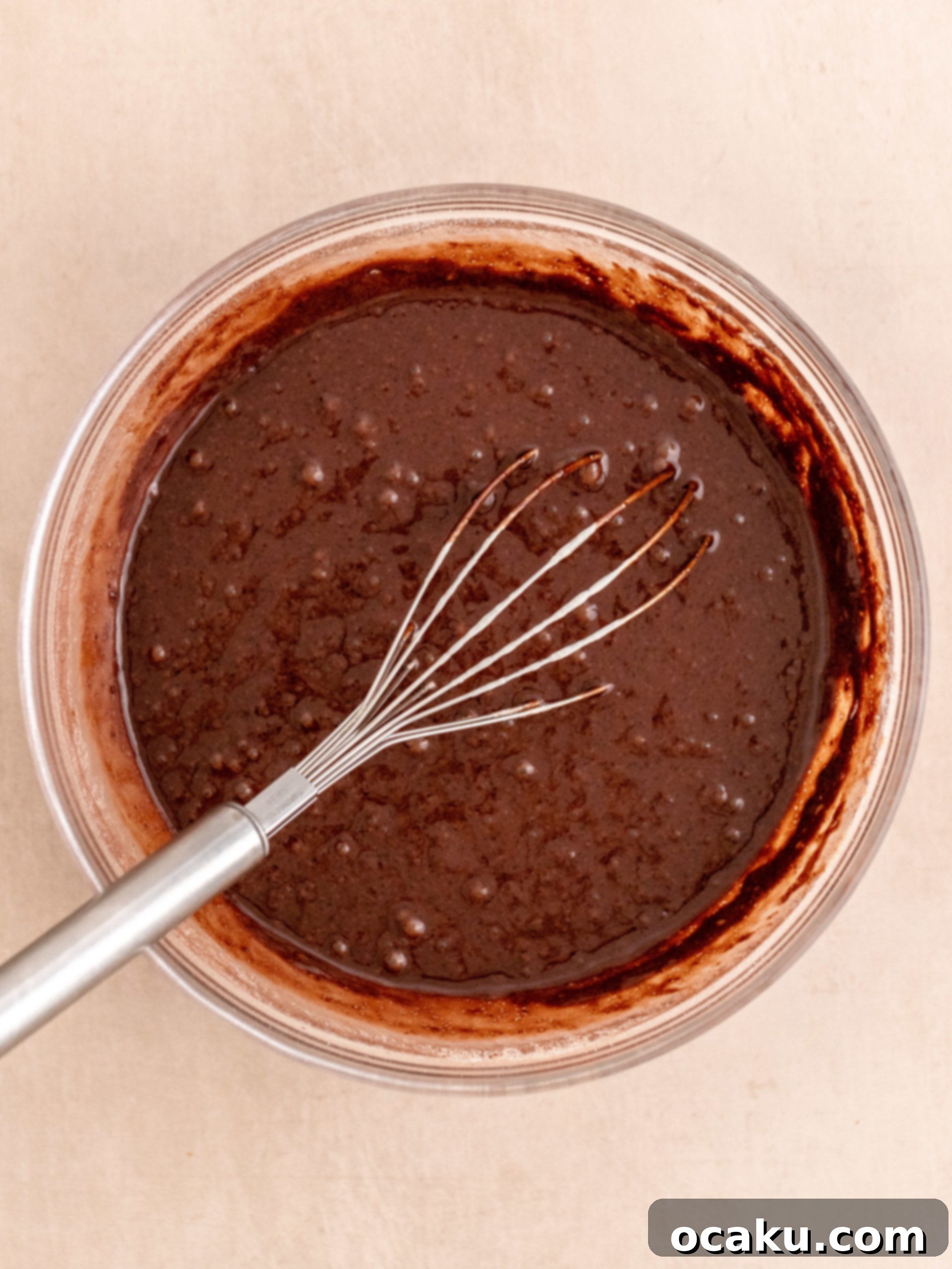 Pouring wet ingredients into dry for cupcake batter