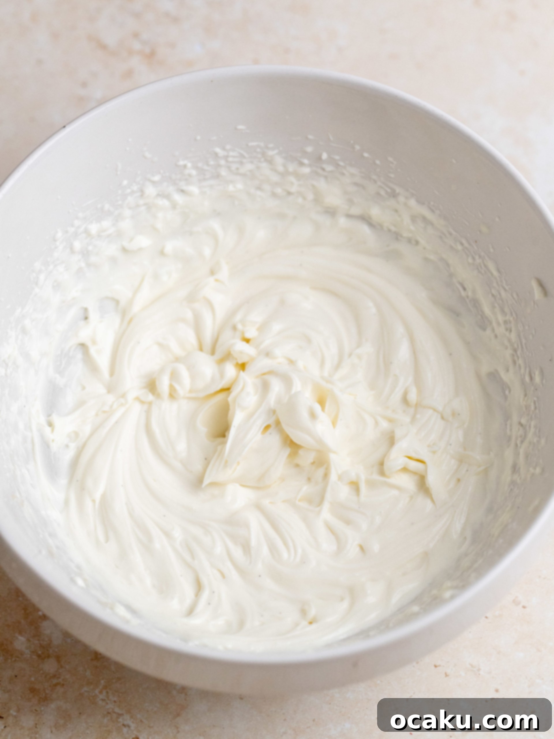Arranging fresh berries on mascarpone cream cake
