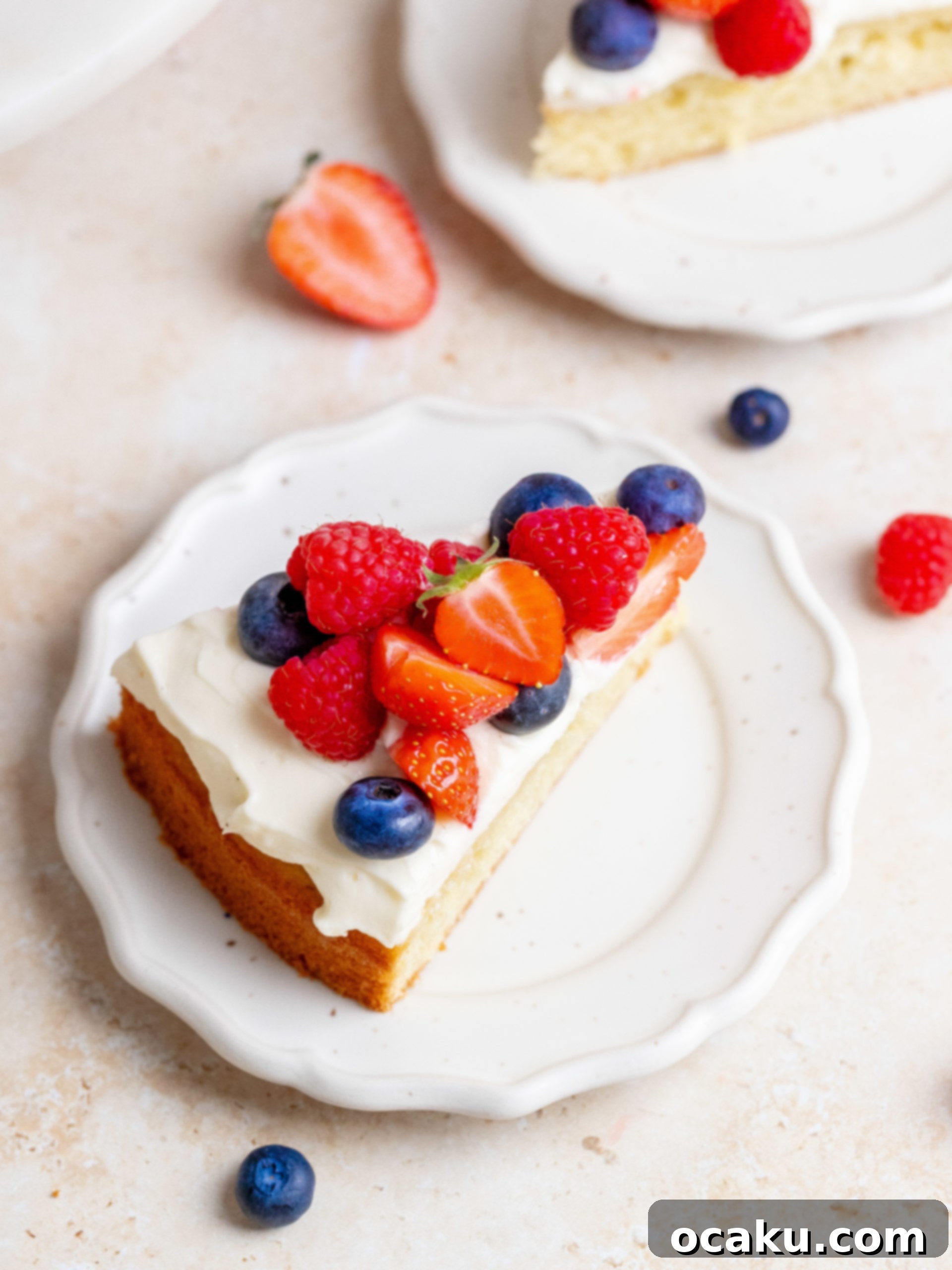 A whole Fresh Berry Cream Cake on a cake stand