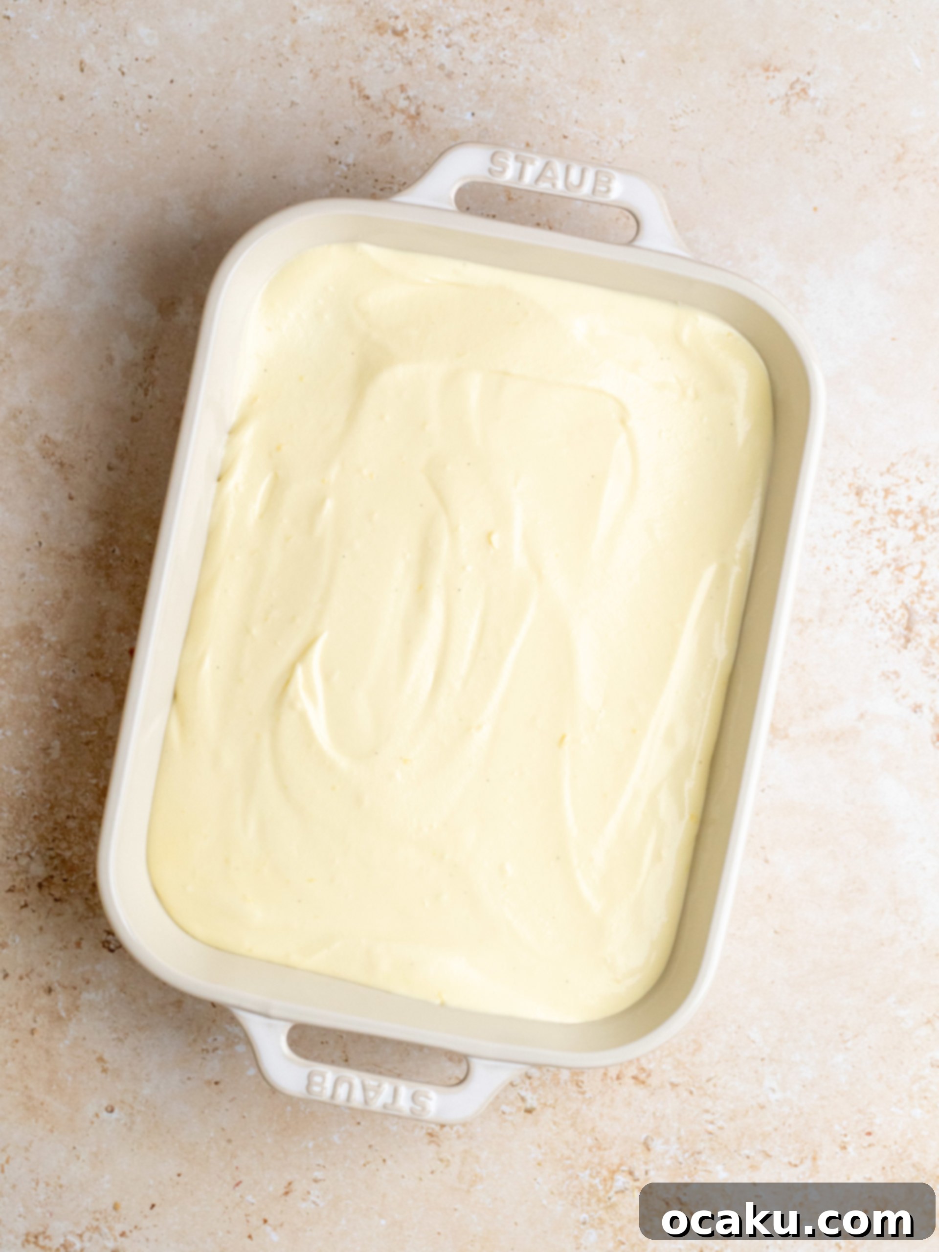 Lemon curd being strained through a sieve