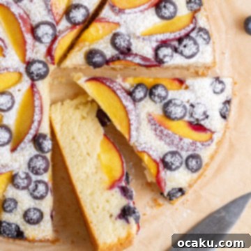 A slice of Peach Blueberry Cake on a plate.