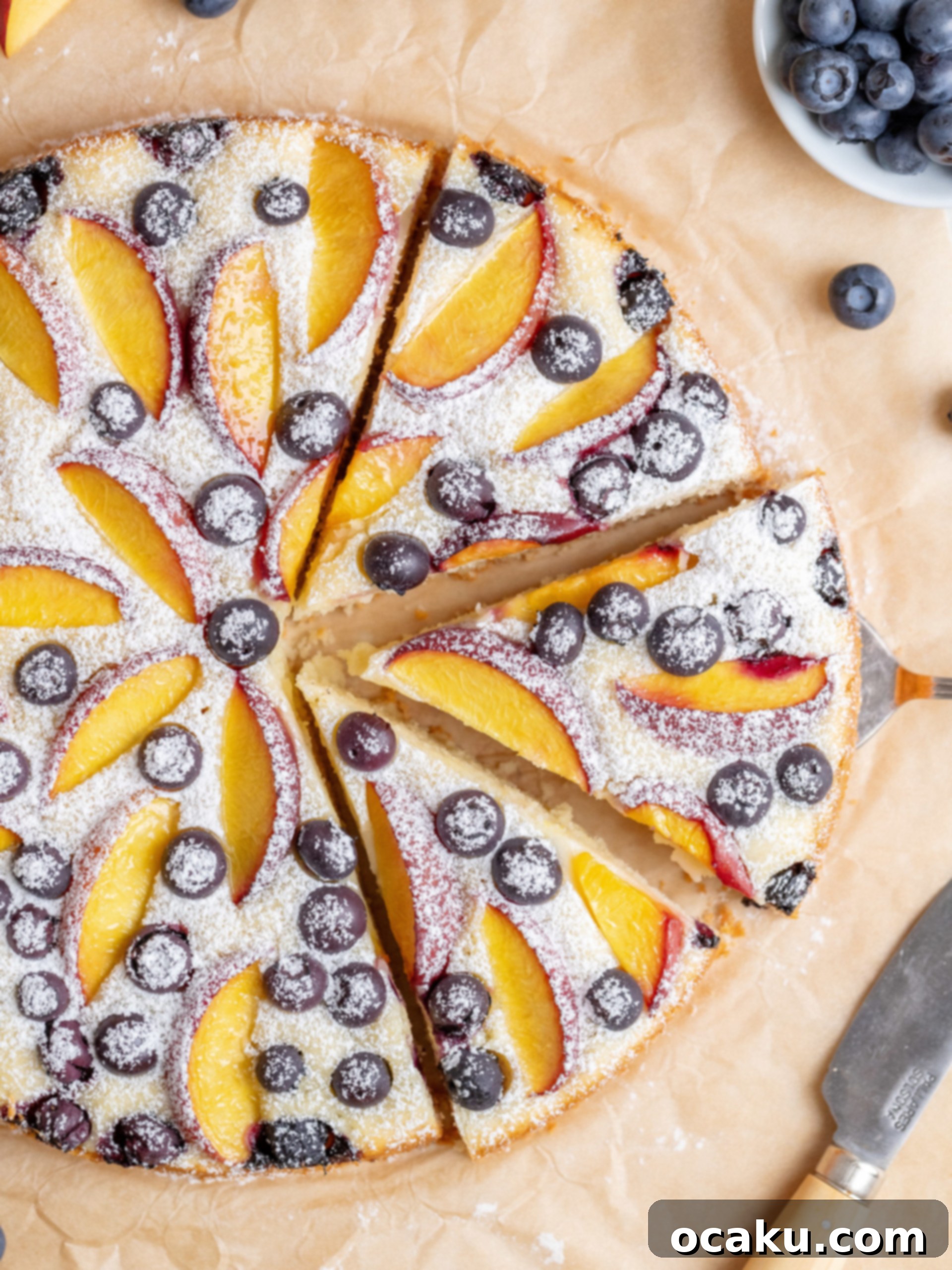 Blueberries scattered over peach slices on the cake batter.