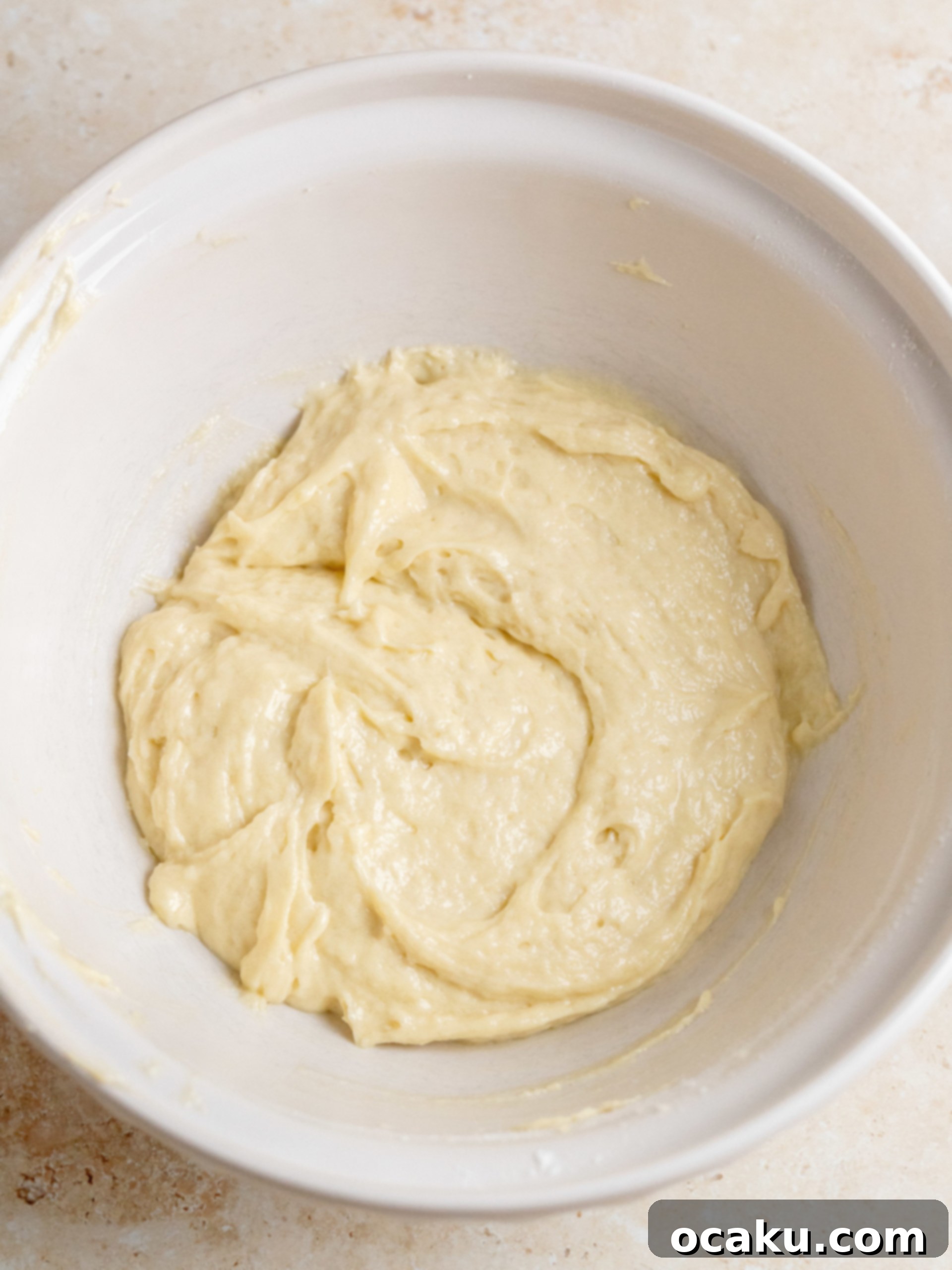 Two separate bowls of cake batter, one plain and one mixed with cinnamon