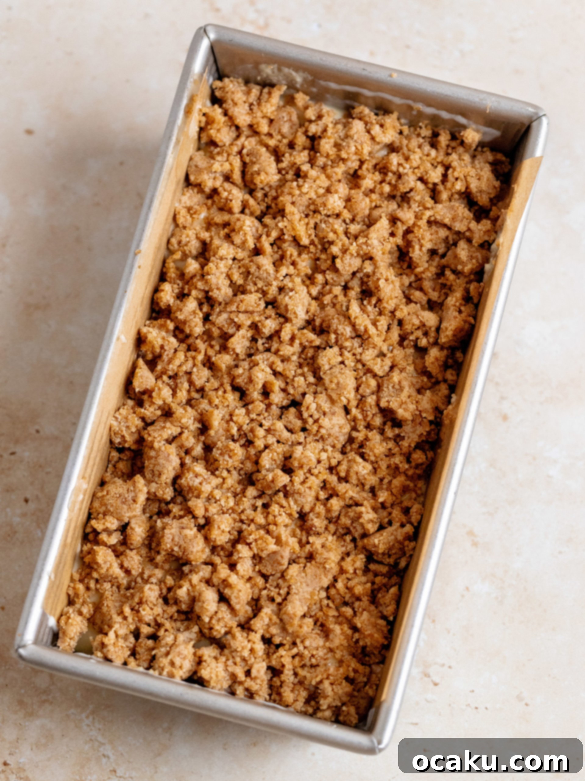 Cinnamon Loaf Cake being drizzled with cream cheese glaze