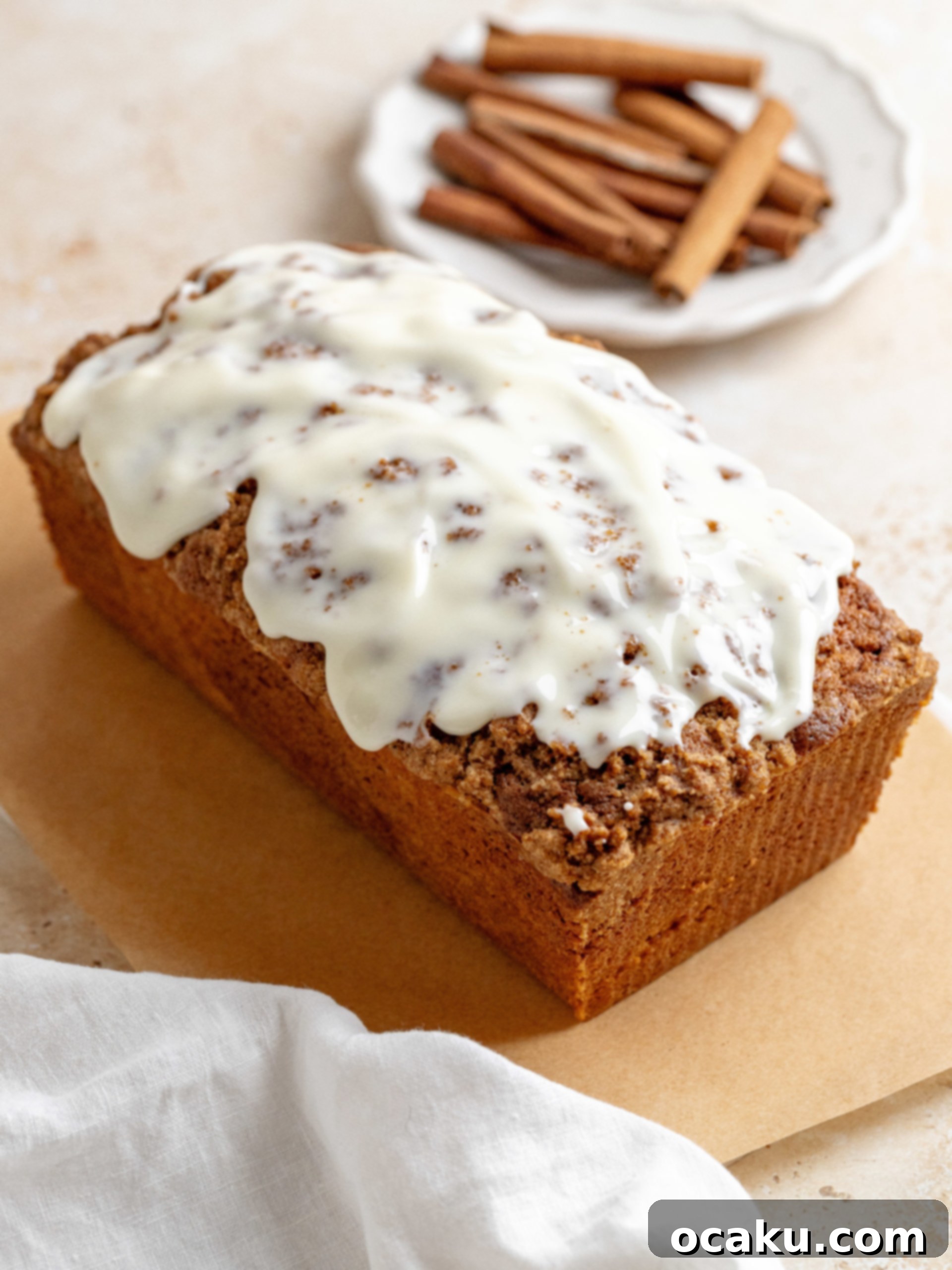 A beautifully glazed Cinnamon Loaf Cake on a serving plate