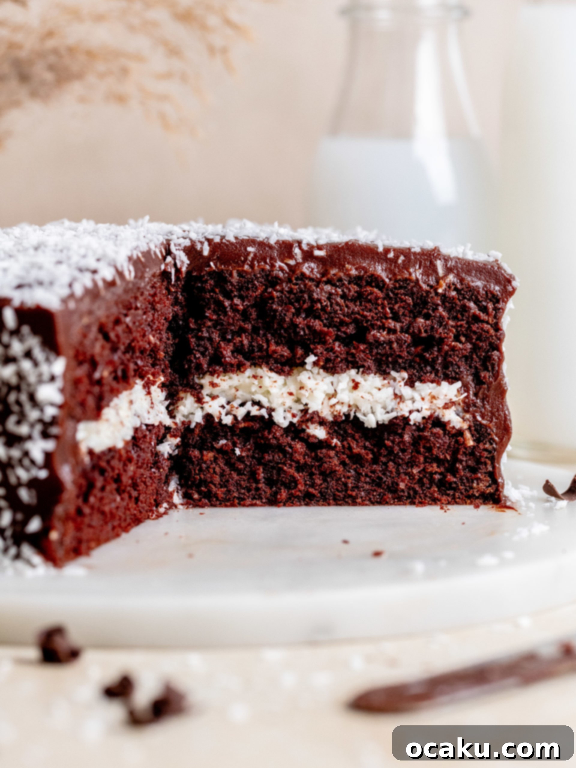 A beautifully sliced Chocolate Coconut Layer Cake revealing its moist layers and creamy filling.