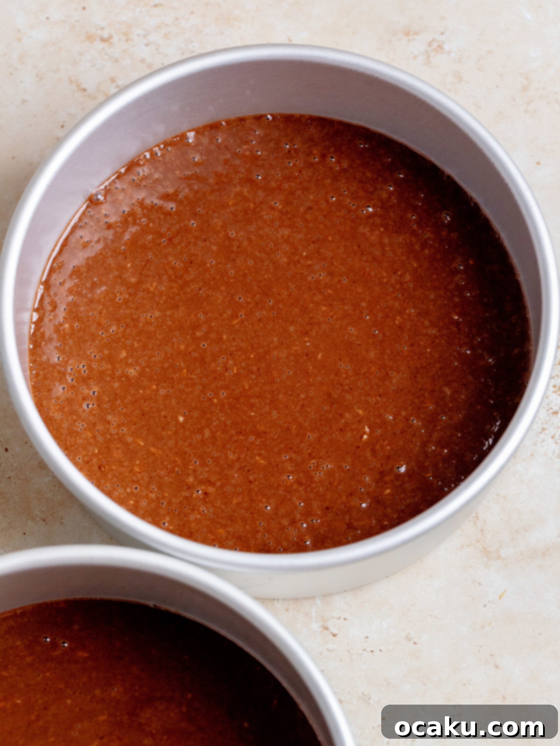 Cake batter poured into baking pans, ready for the oven.