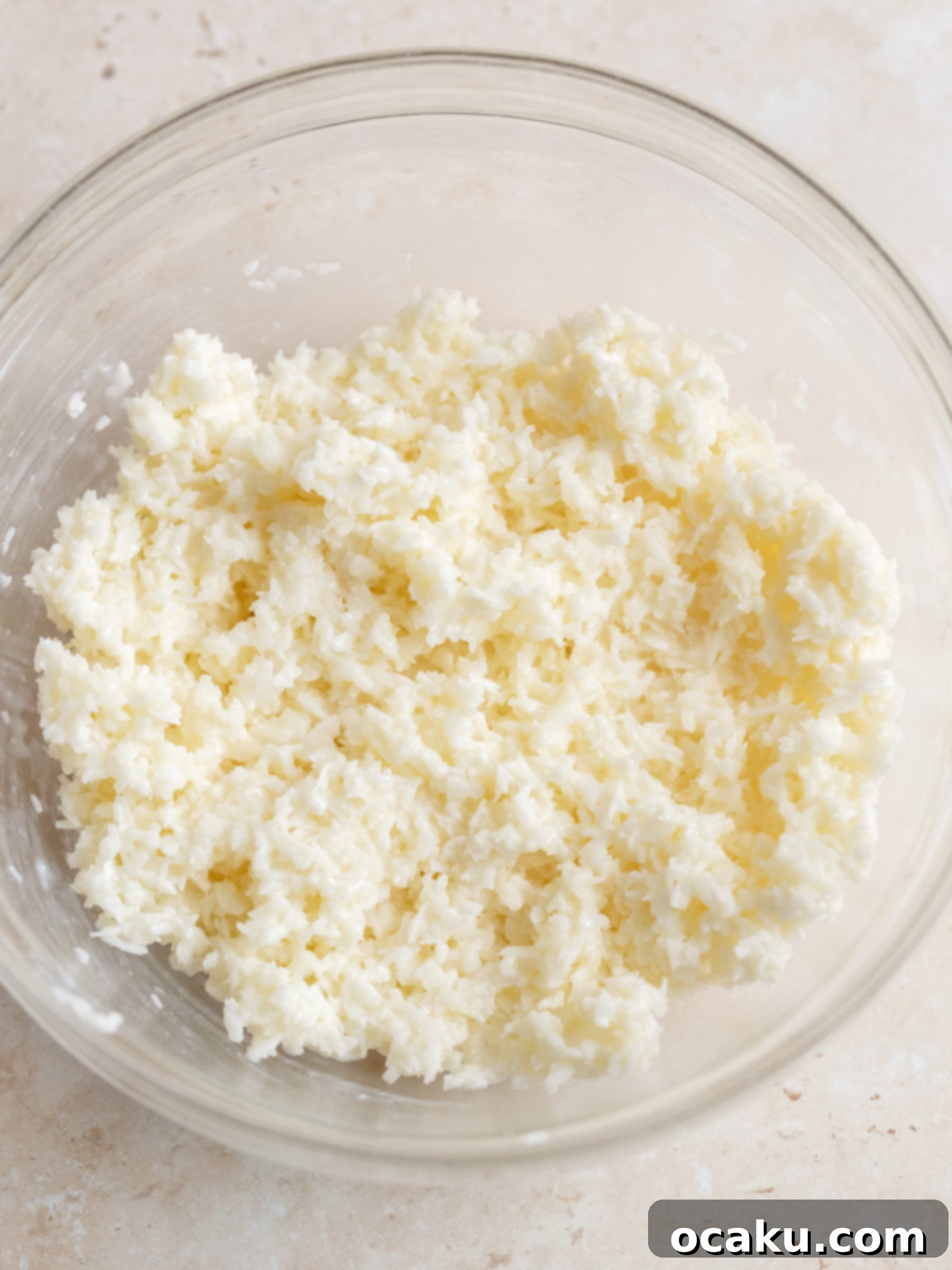 Coconut filling being spread onto a cake layer.