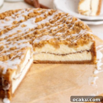 A slice of homemade Coffee Cake Cheesecake with a vanilla glaze drizzle