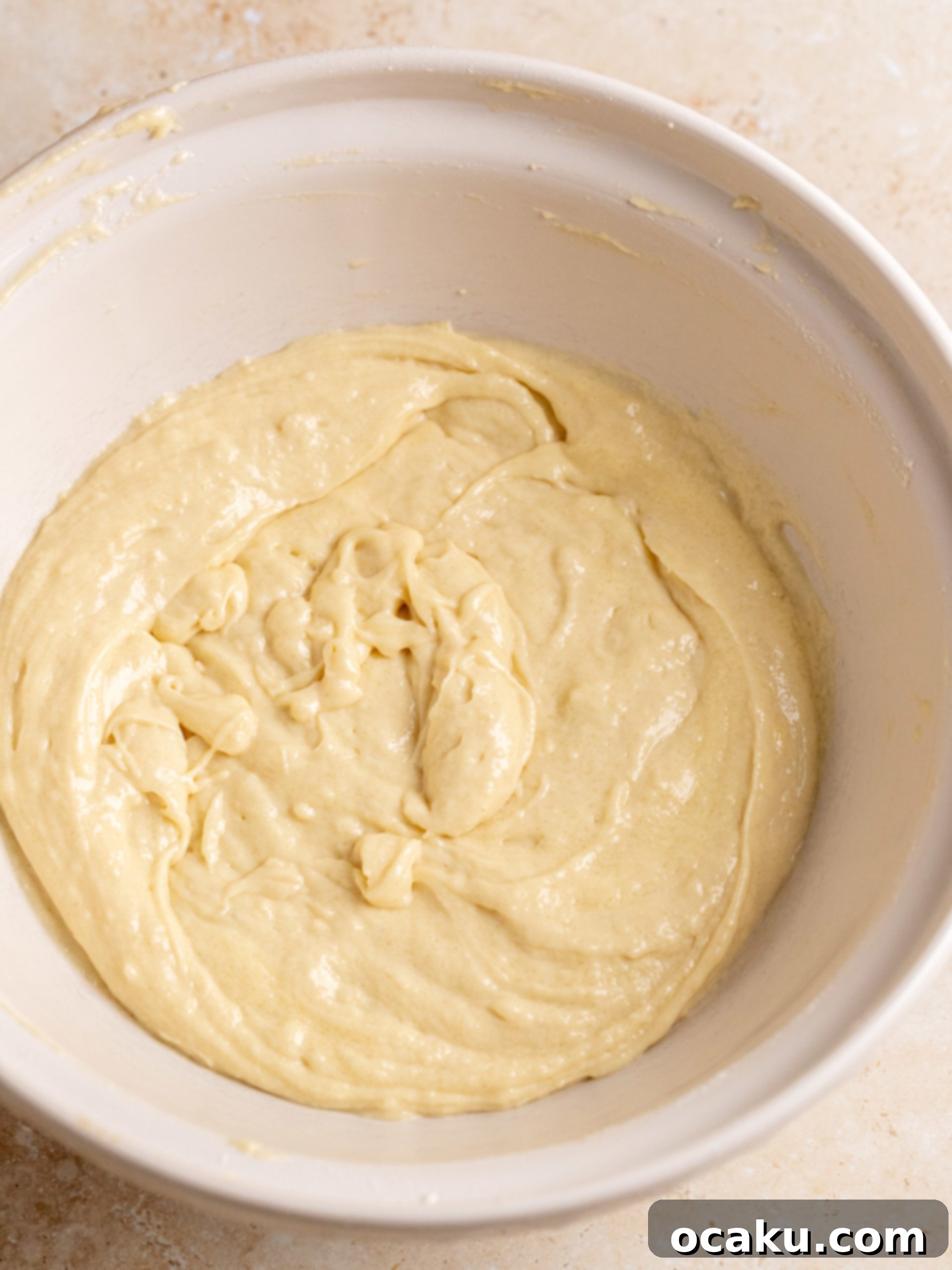 Espresso-Soaked Tiramisu Masterpiece 4 Wet ingredients being mixed in a bowl for the Tiramisu Layer Cake batter.