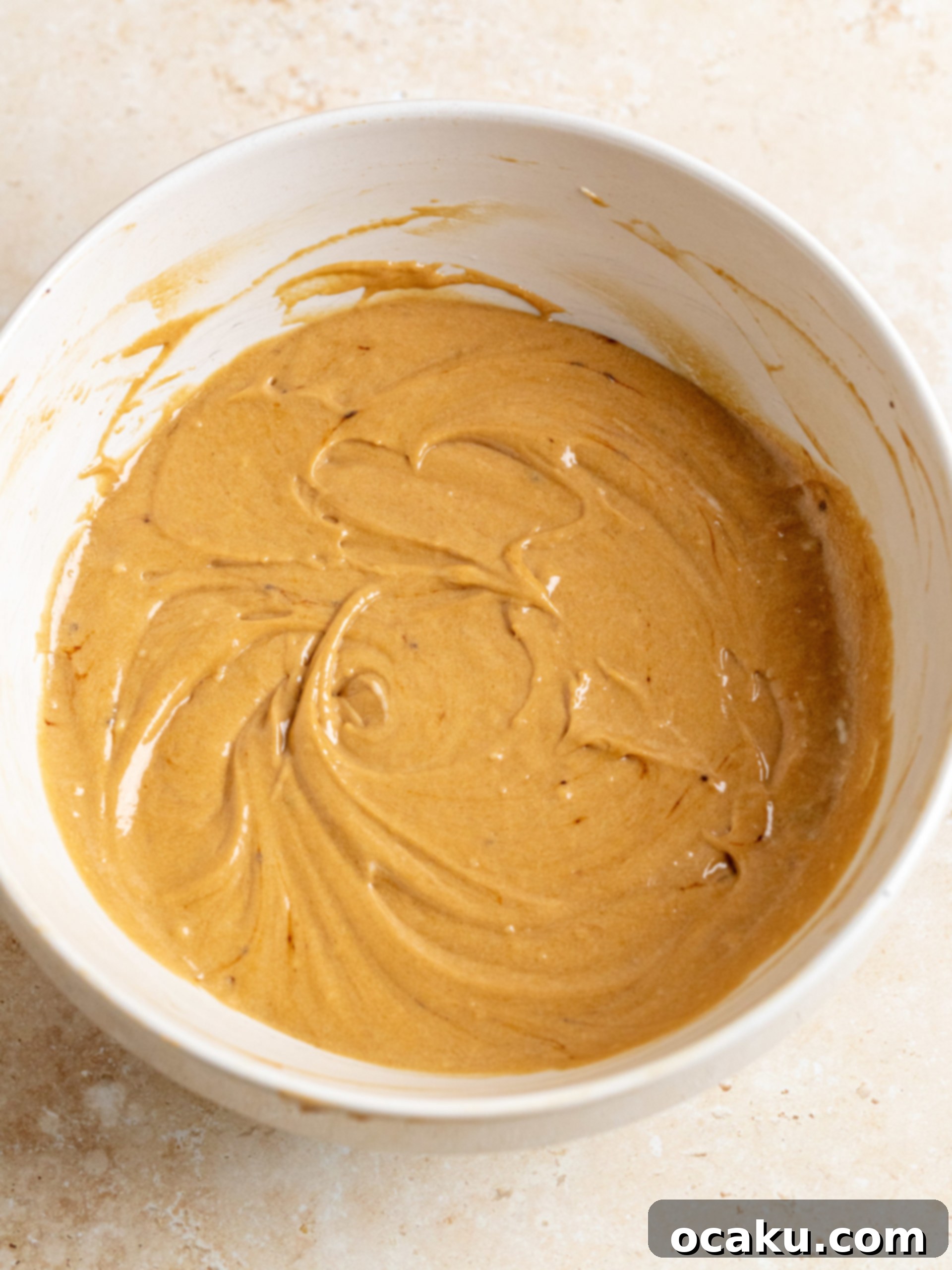 Espresso-Soaked Tiramisu Masterpiece 5 Dry ingredients being folded into the wet batter.