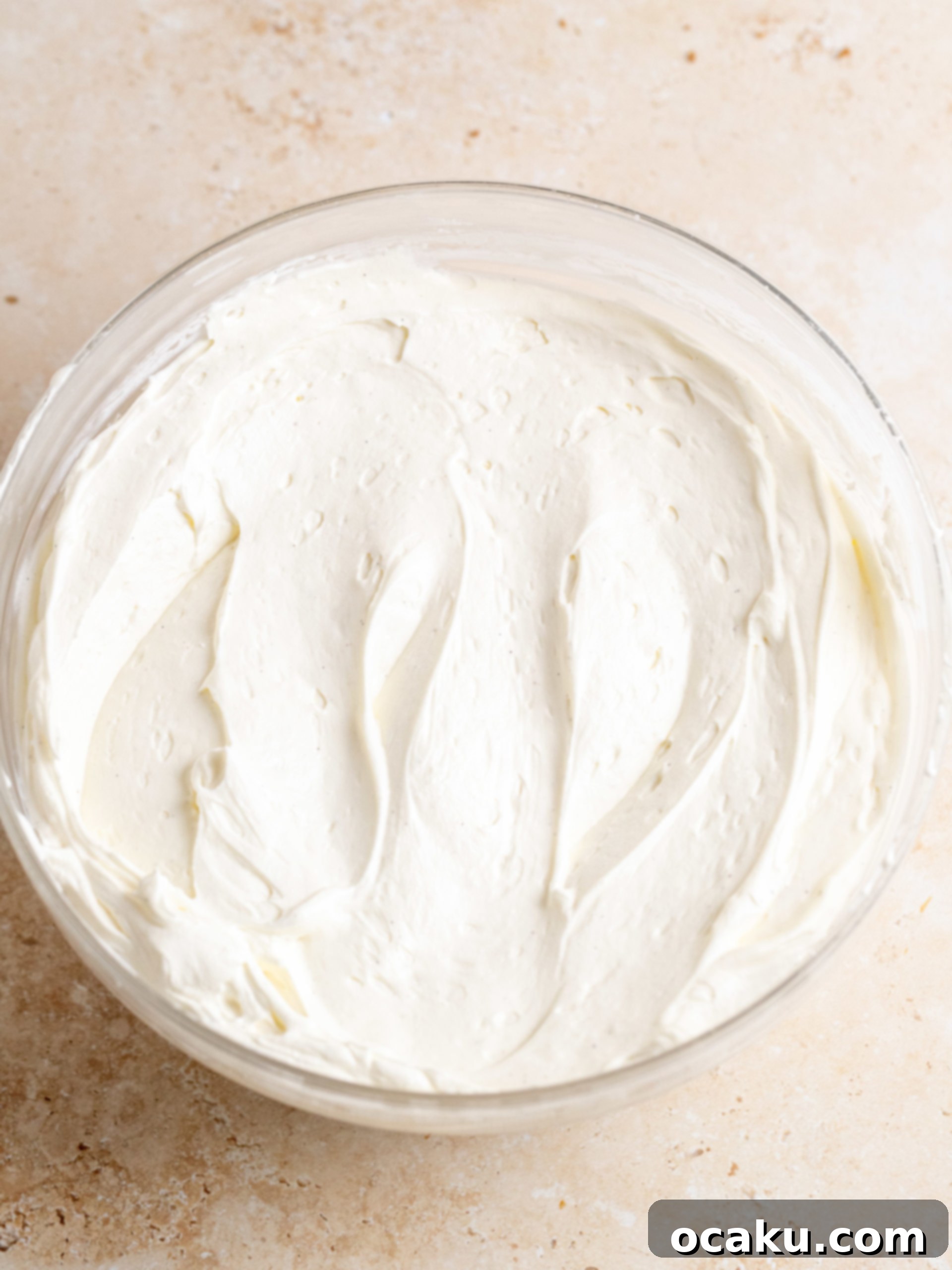 Espresso-Soaked Tiramisu Masterpiece 8 Whipping mascarpone cheese, powdered sugar, and vanilla bean paste for frosting.