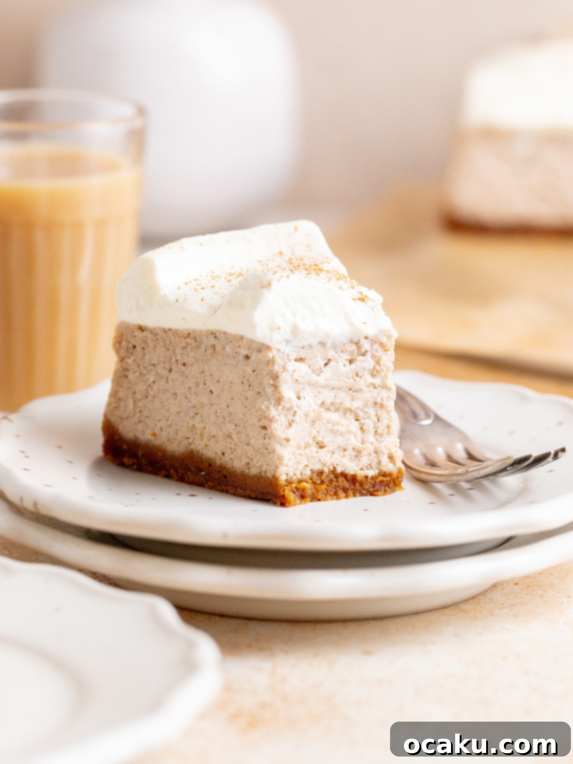 A whole Chai Spice Cheesecake on a serving stand, ready to be sliced.