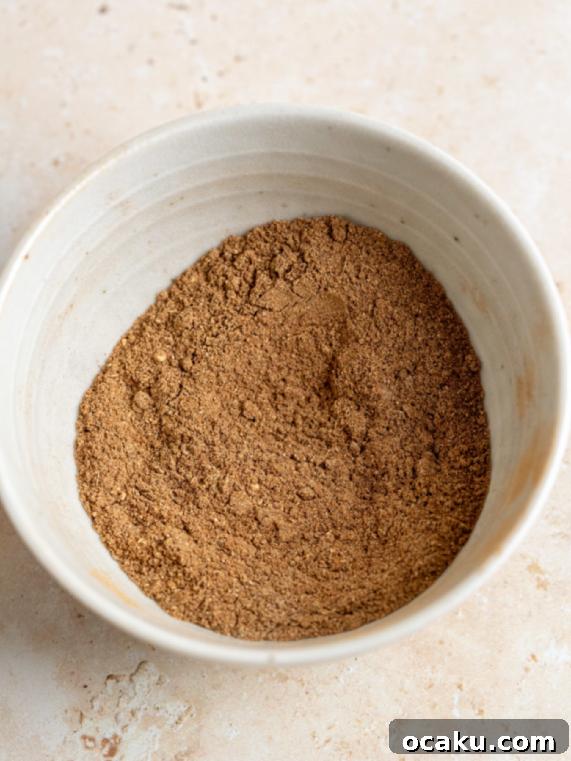 Mixing the cream cheese in a stand mixer.