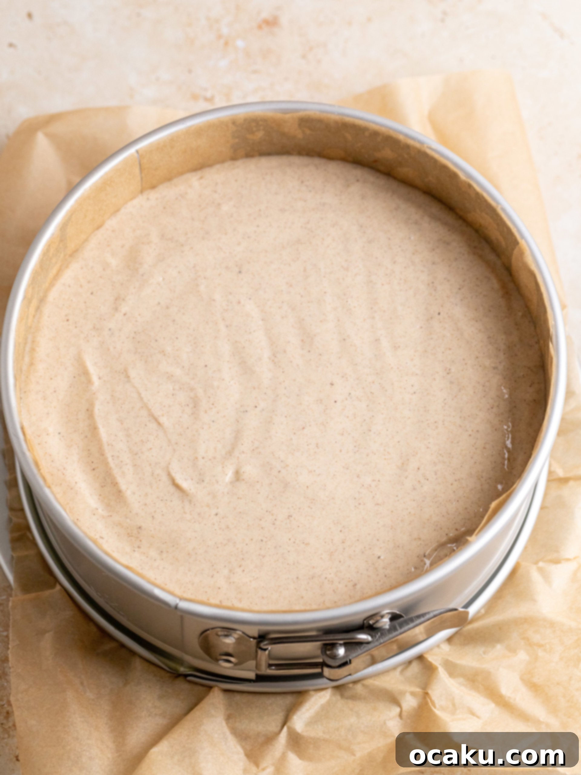 Chai Spice Cheesecake cooling in the oven with the door ajar.