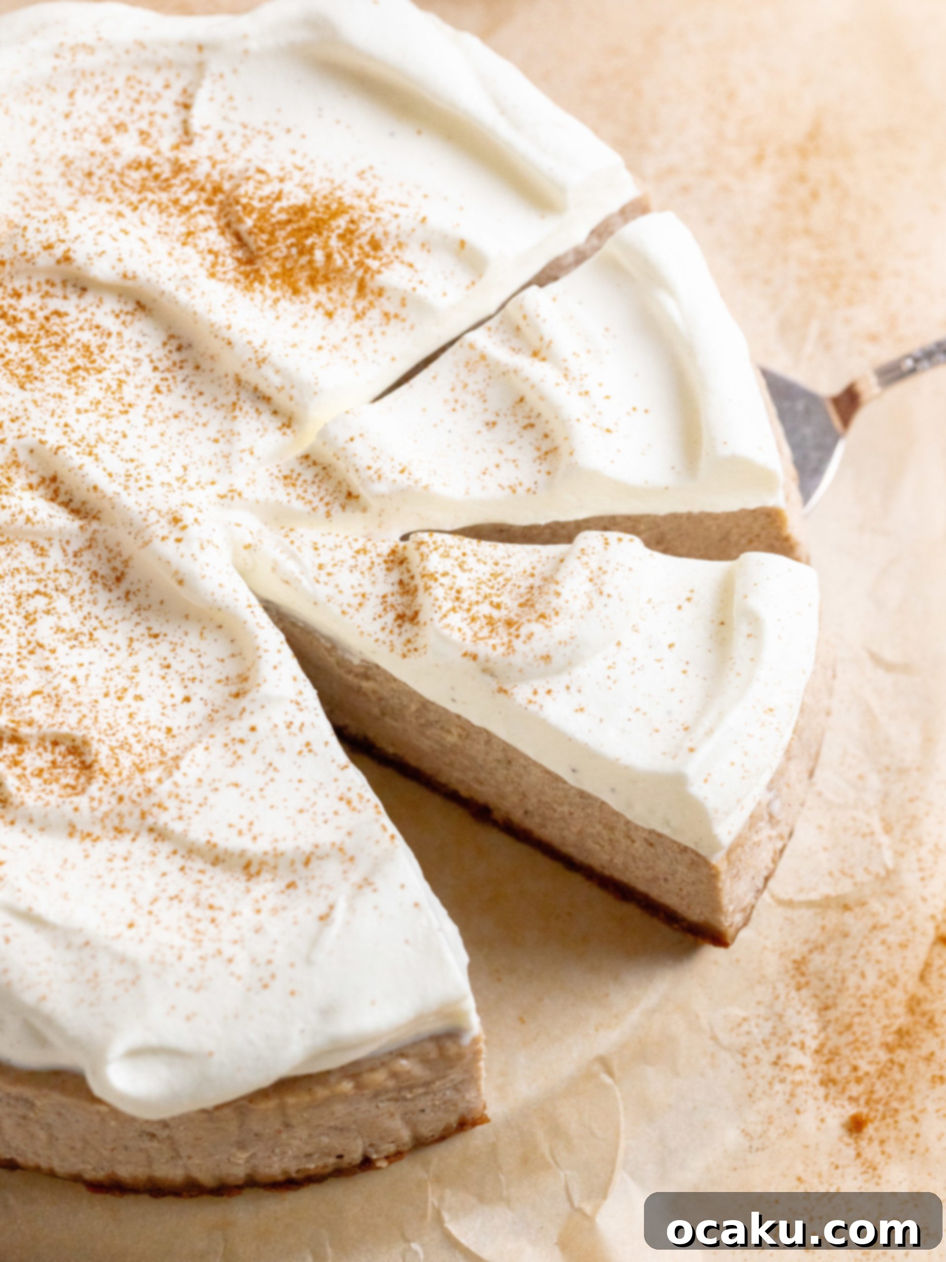 A slice of Chai Spice Cheesecake on a plate, showing the creamy texture and Biscoff crust.