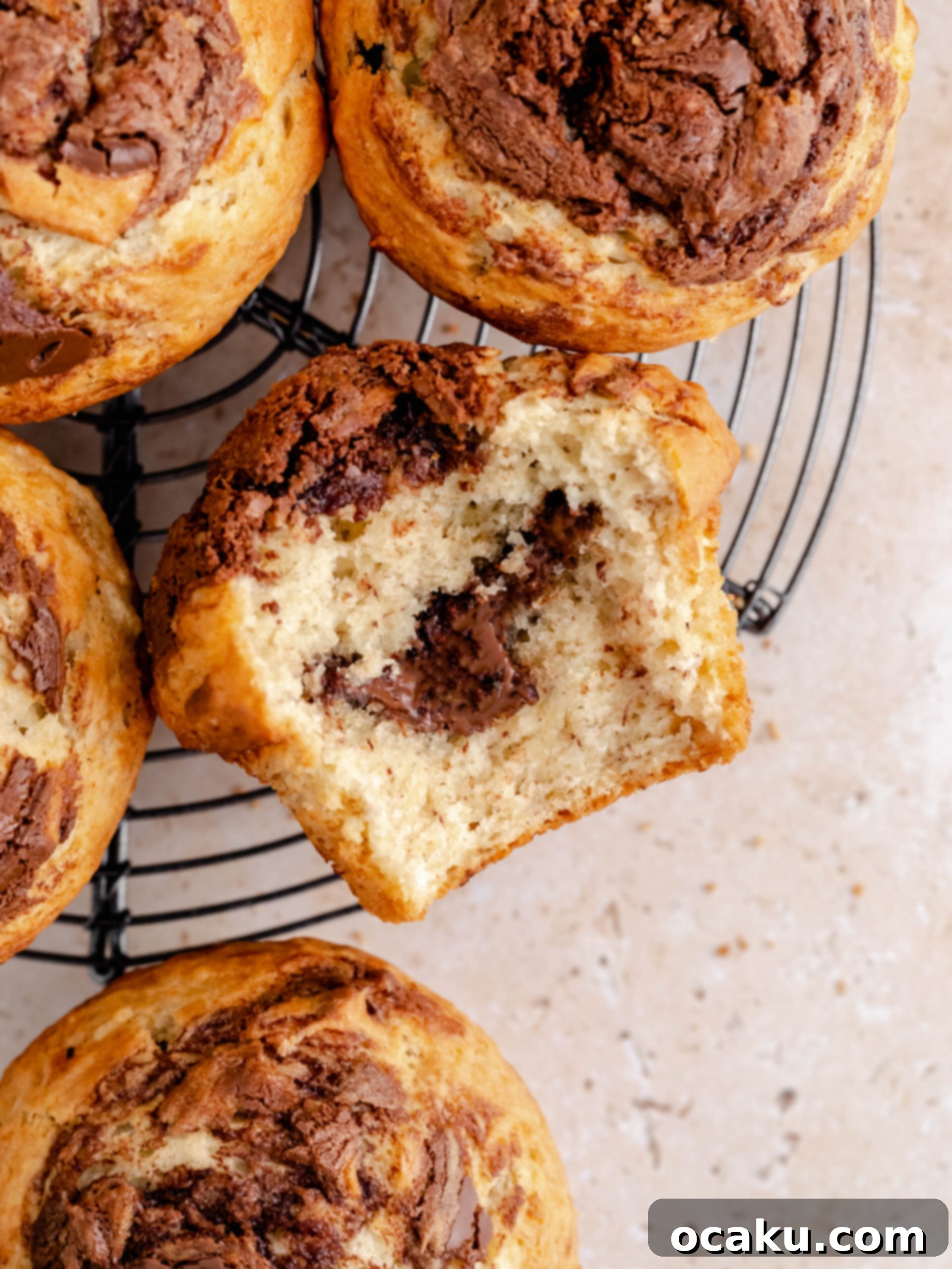 Close-up of freshly baked banana Nutella muffins with a golden-brown top and visible Nutella swirl