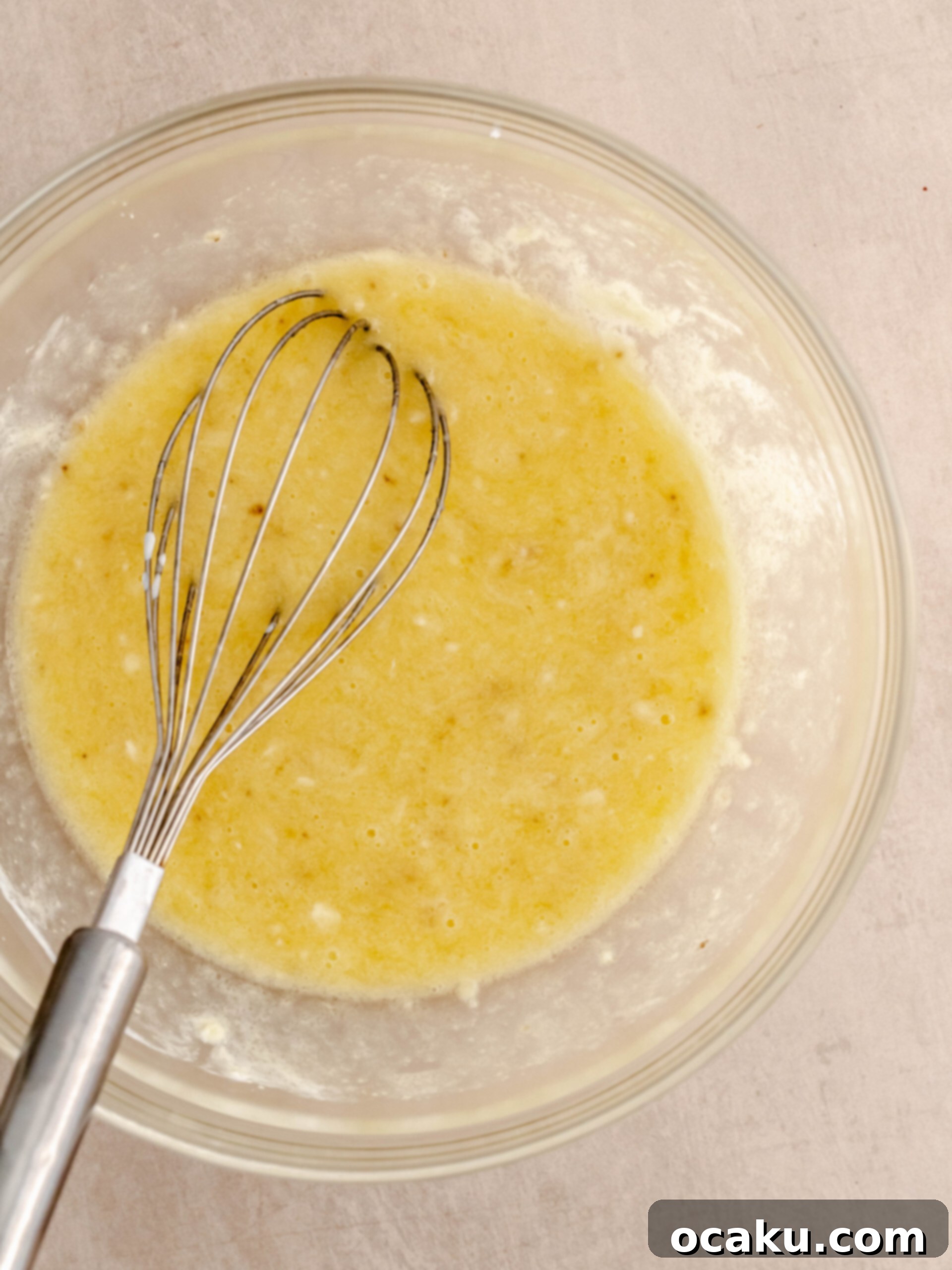 Whisking melted butter, sugar, and egg