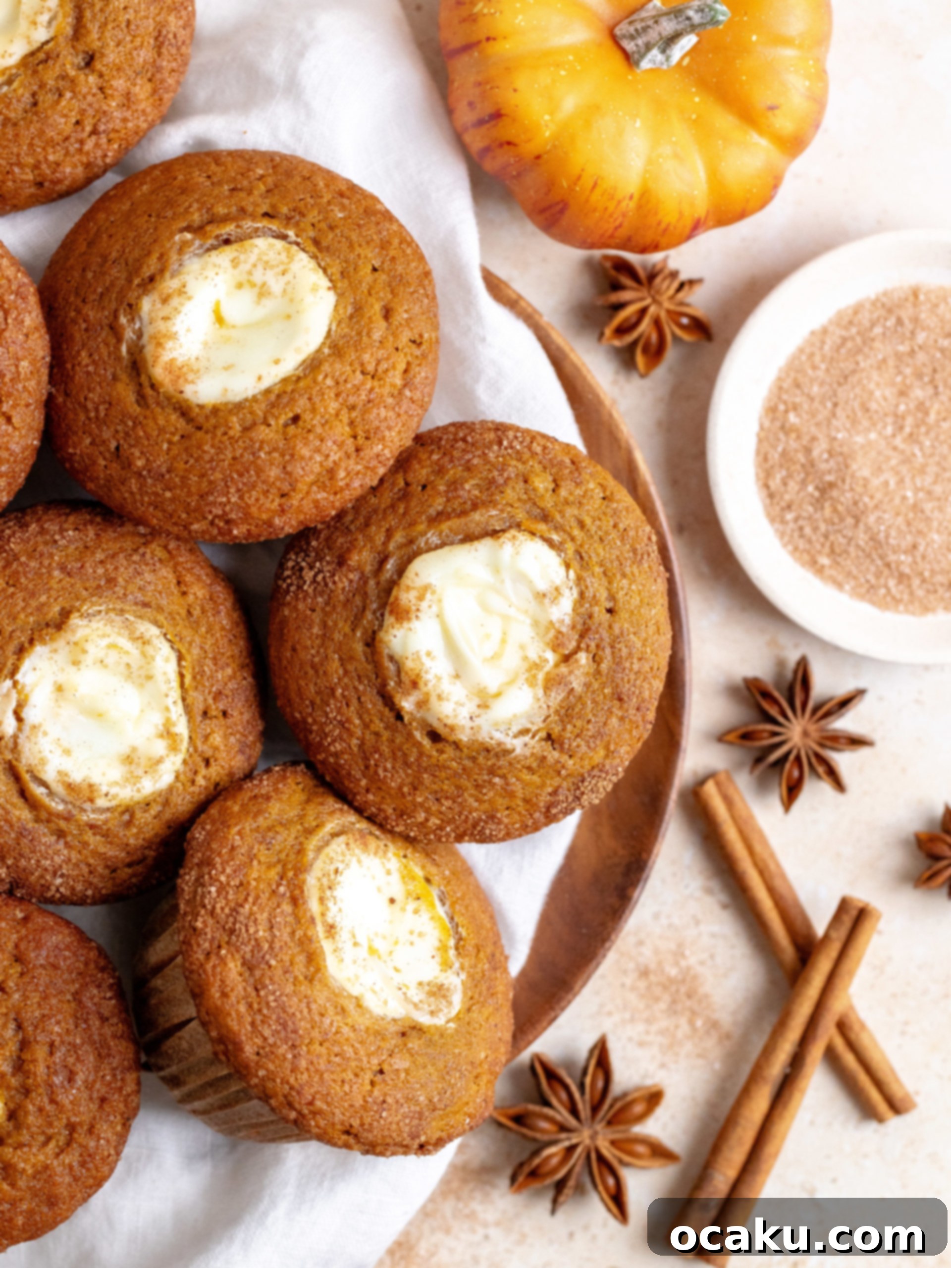 Two pumpkin cream cheese muffins displaying their soft texture and creamy filling.