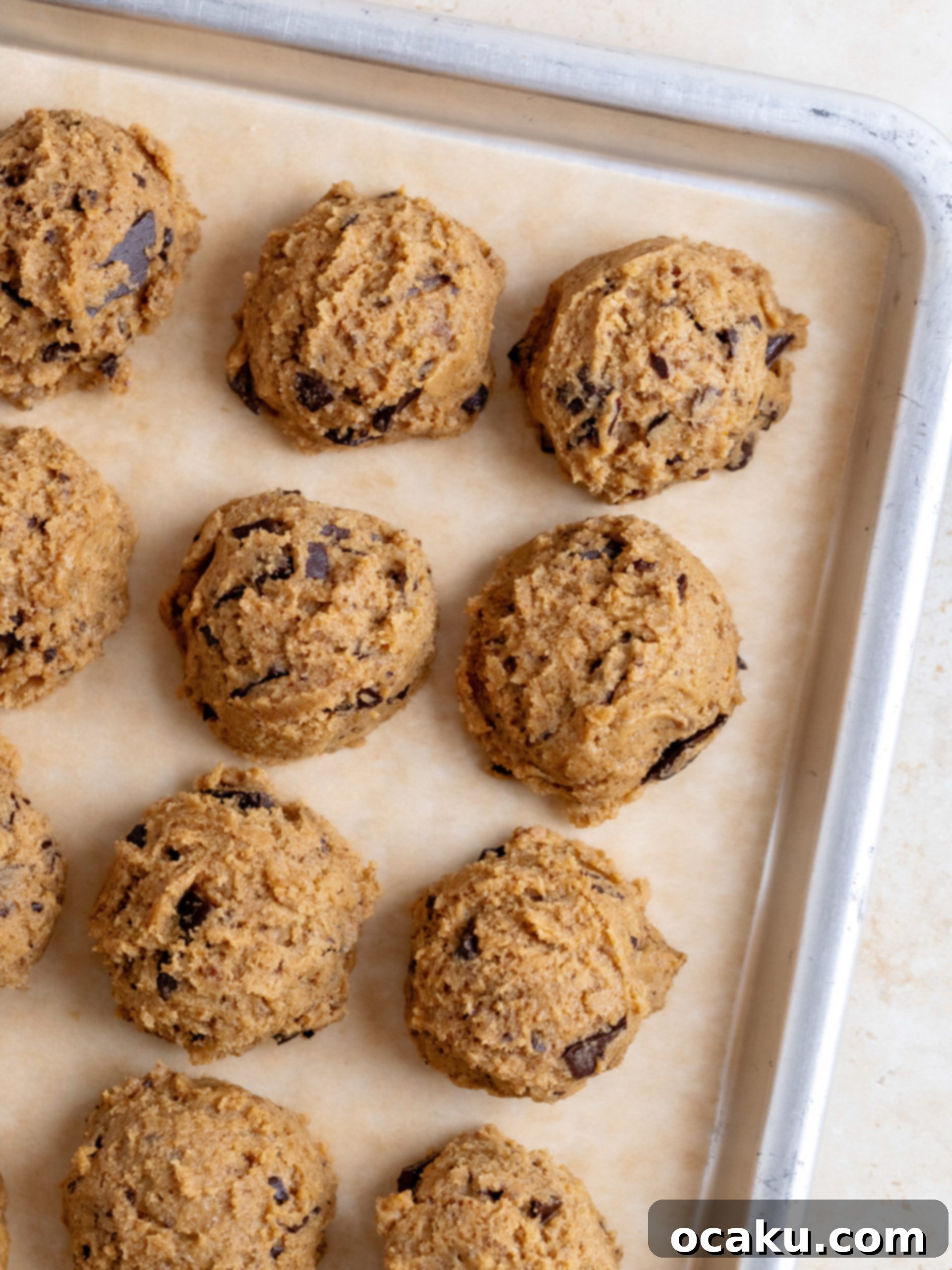 Scooped cookie dough chilling in the refrigerator, essential for perfect texture.