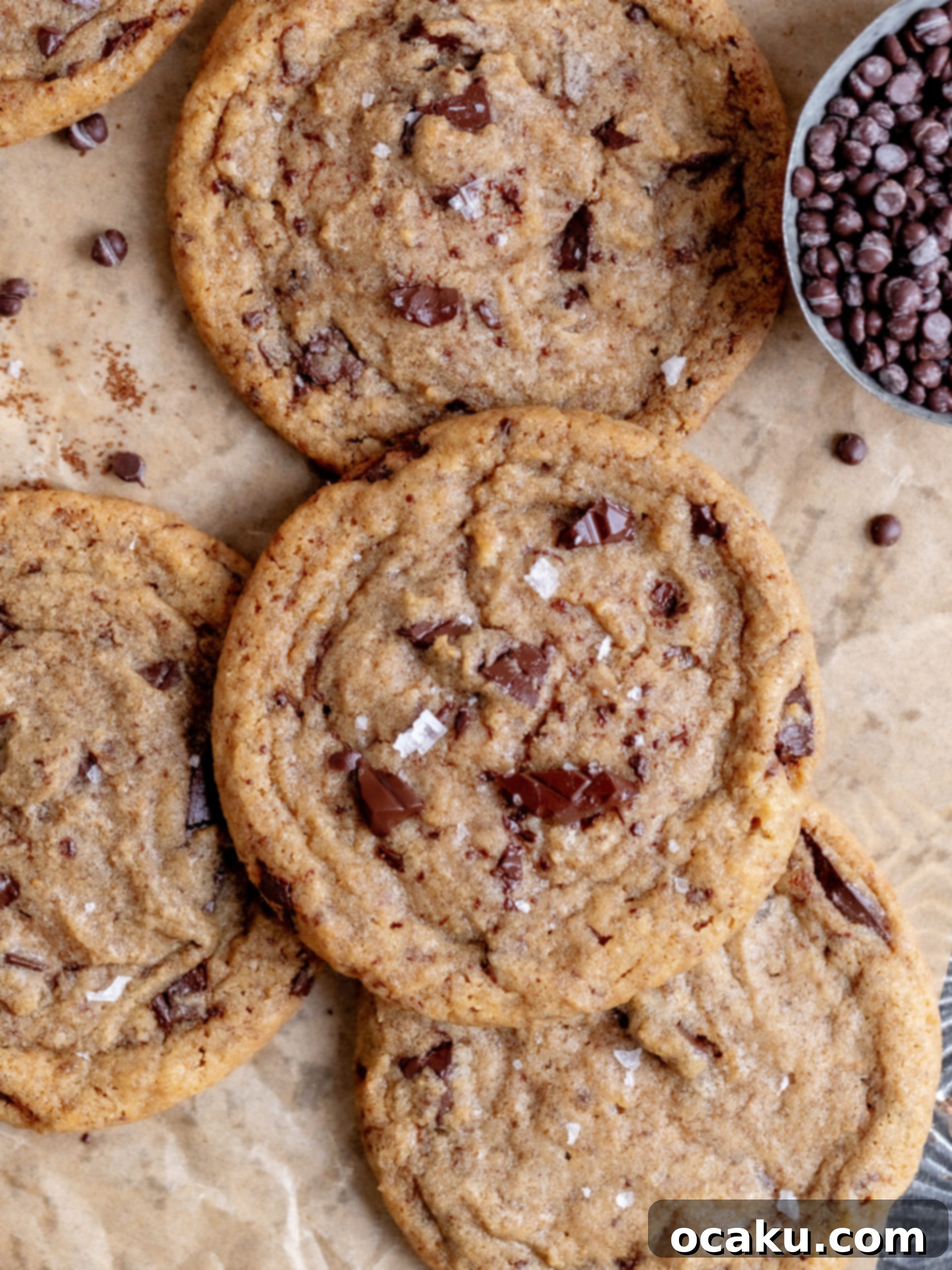 Freshly baked chocolate chip coffee cookies cooling on a wire rack, with flaky sea salt visible.
