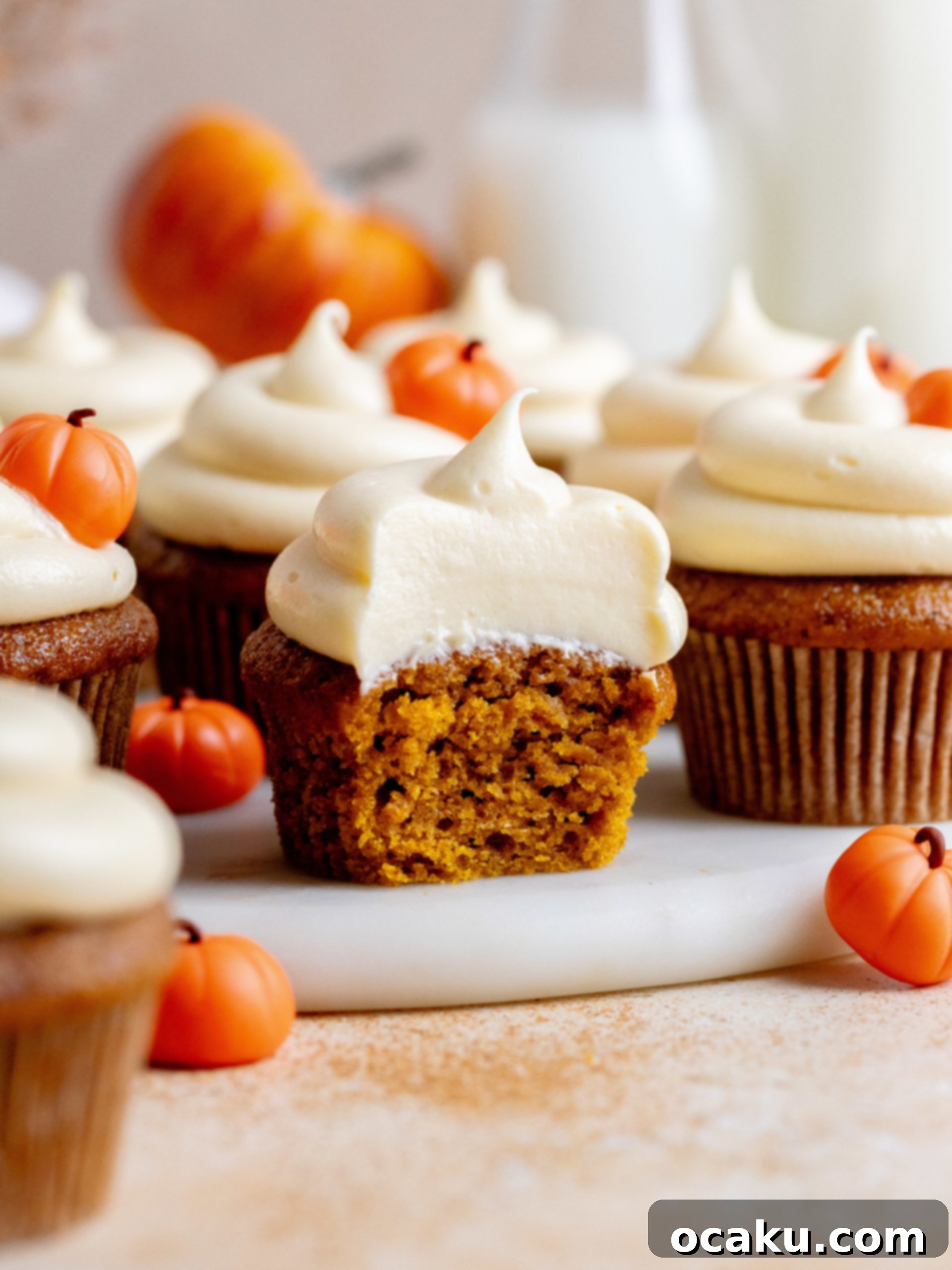 Finished pumpkin cupcakes with frosting and autumn decorations.