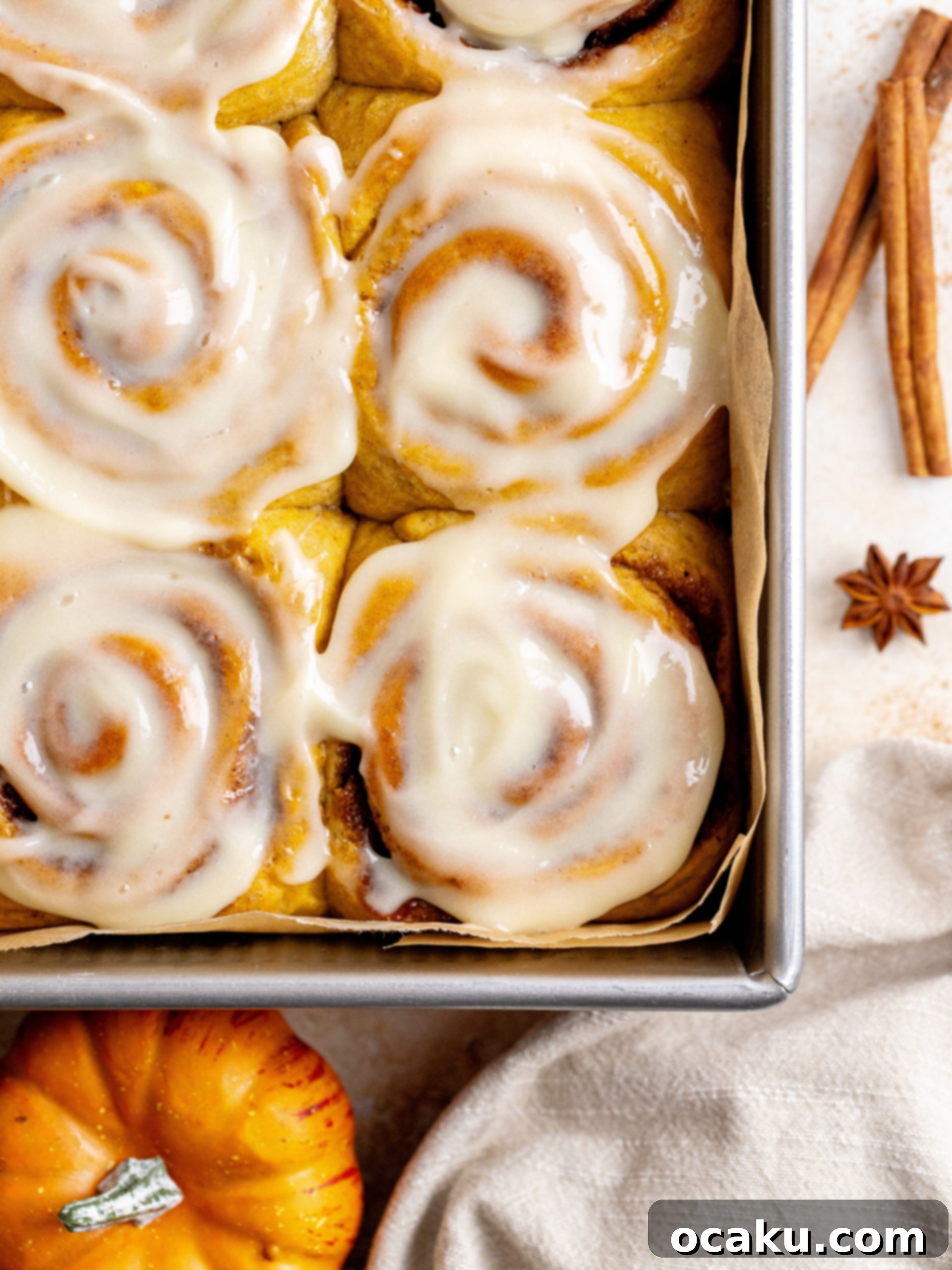 Close-up of the gooey pumpkin spice filling inside unbaked cinnamon rolls.