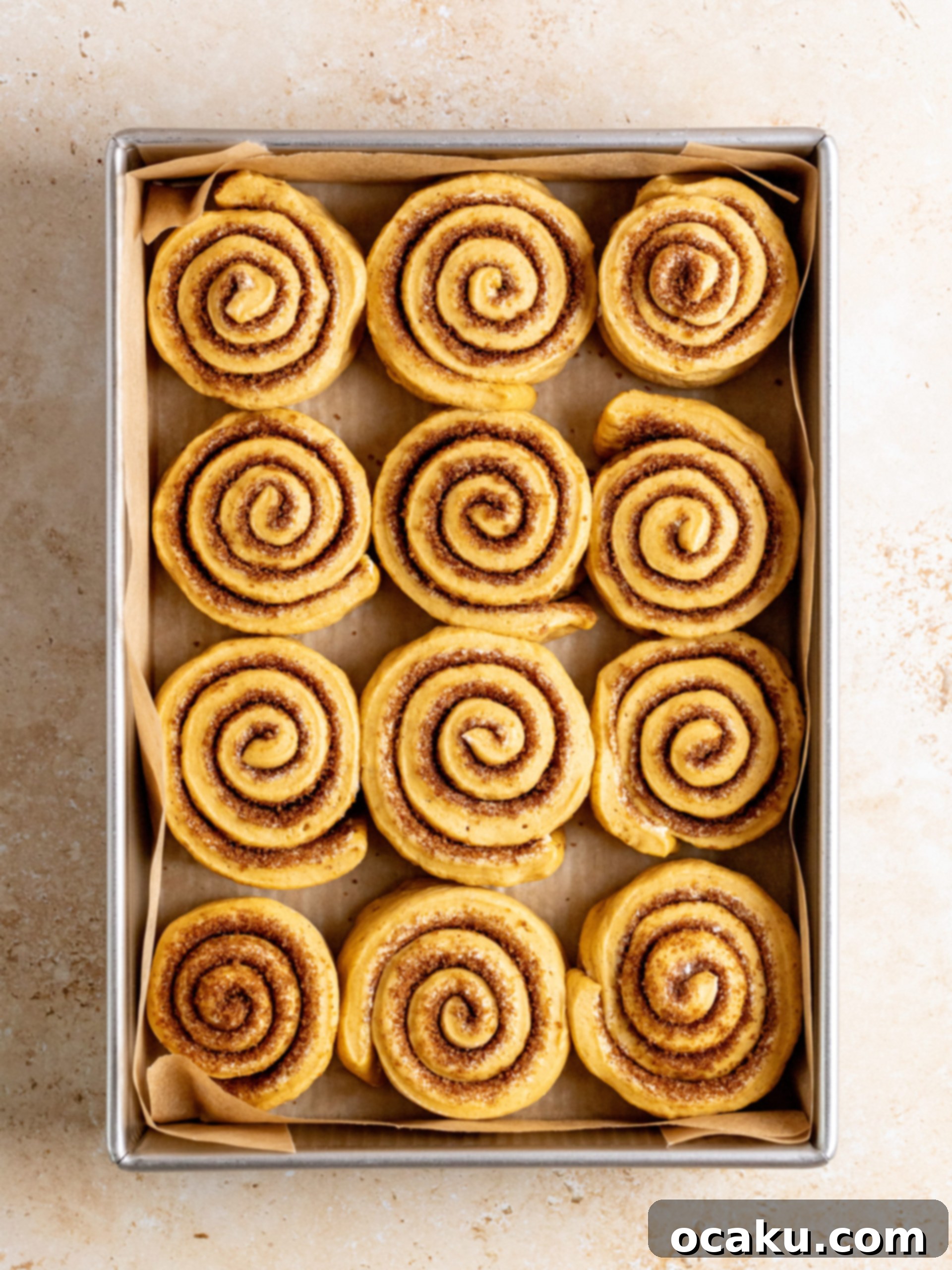 Pumpkin spice sugar mixture sprinkled over buttered dough.