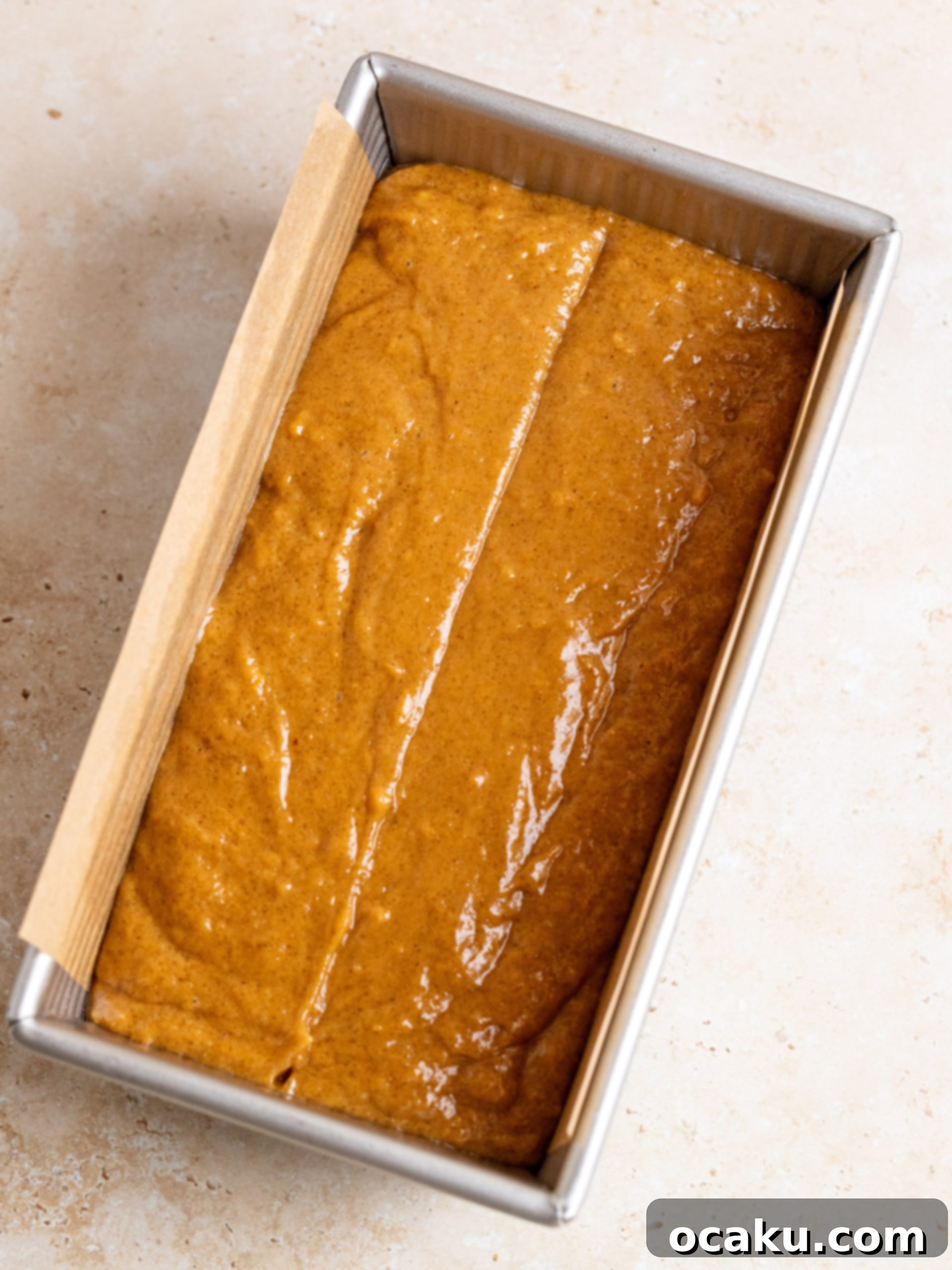 A close-up shot of sweet potato bread topped with cream cheese frosting, ready to be served.