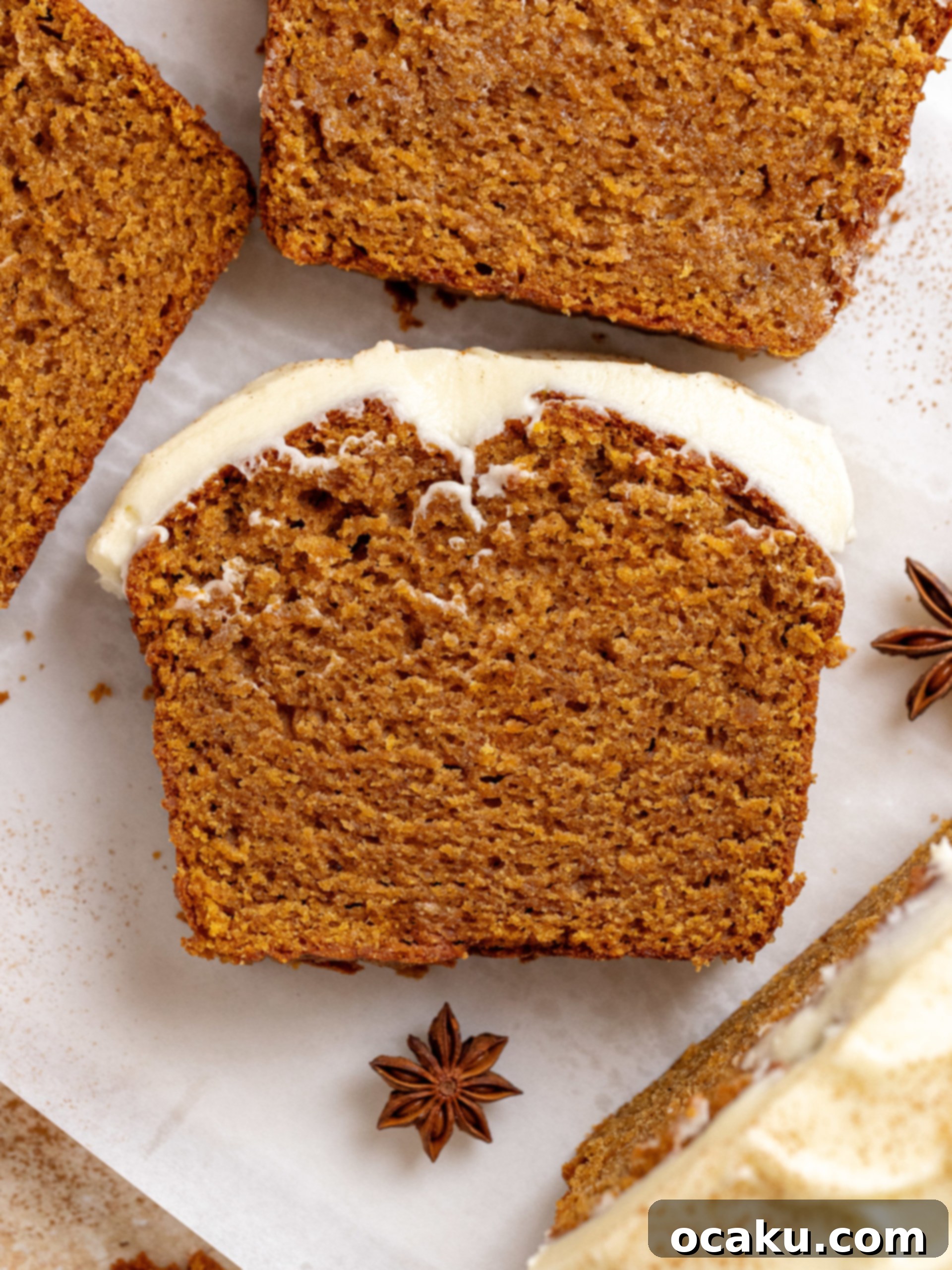 A whole sweet potato bread loaf on a wire rack, covered with cream cheese frosting and a sprinkle of cinnamon.