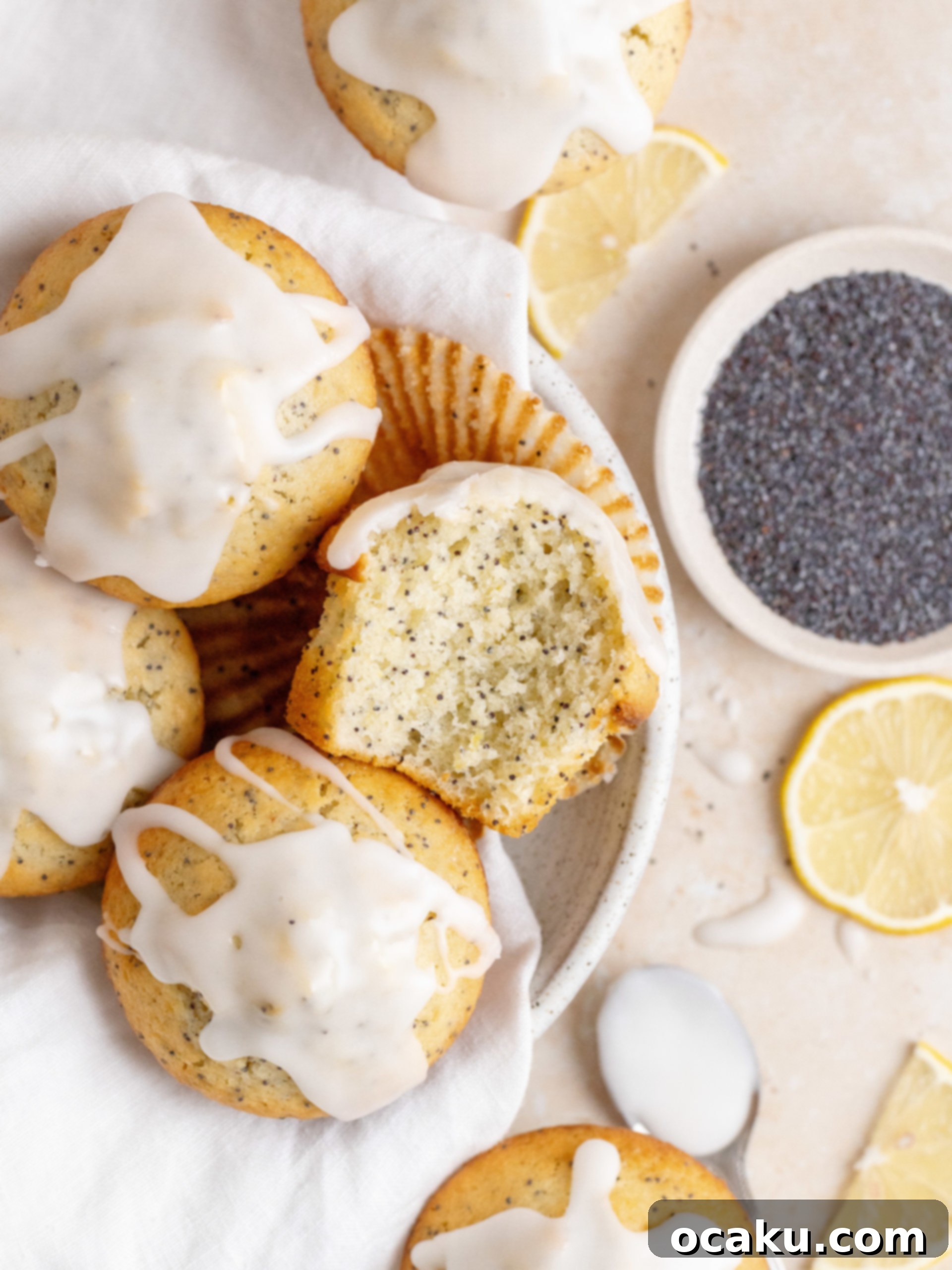 Top view of Lemon Poppy Seed Muffins drizzled with lemon glaze on a wire rack.