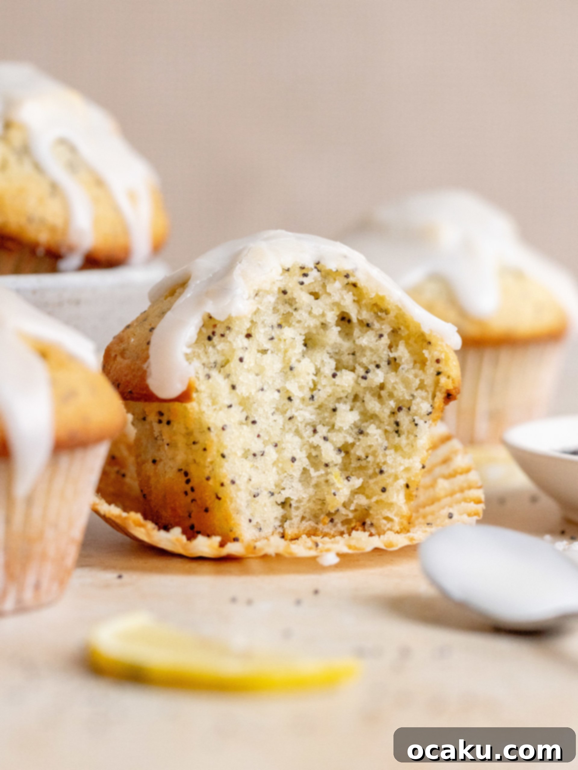 Assortment of Lemon Poppy Seed Muffins on a serving platter, some with glaze.