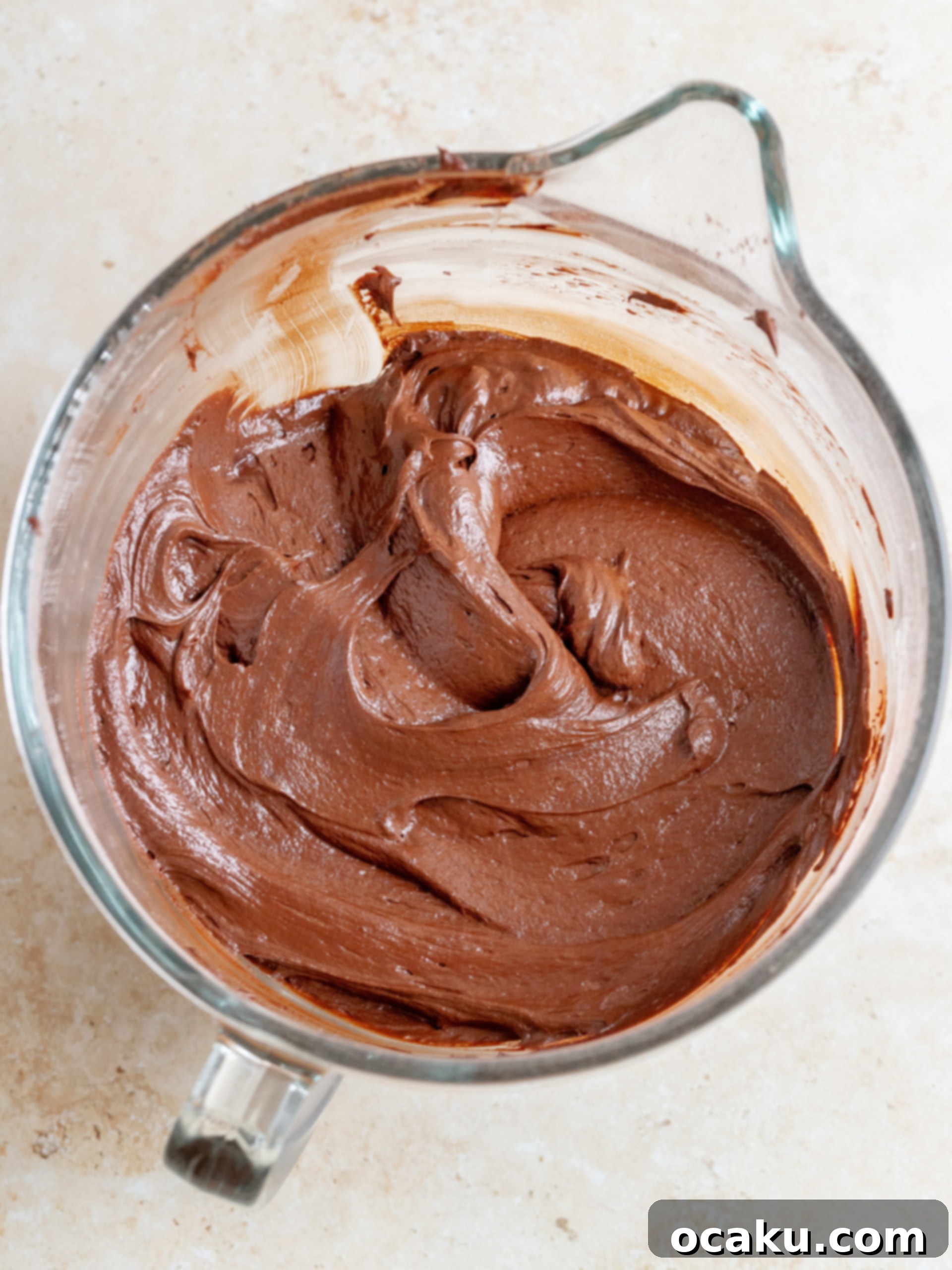 Matilda's Irresistibly Moist Cake 5 A smooth, dark chocolate cake batter ready to be poured into baking pans.