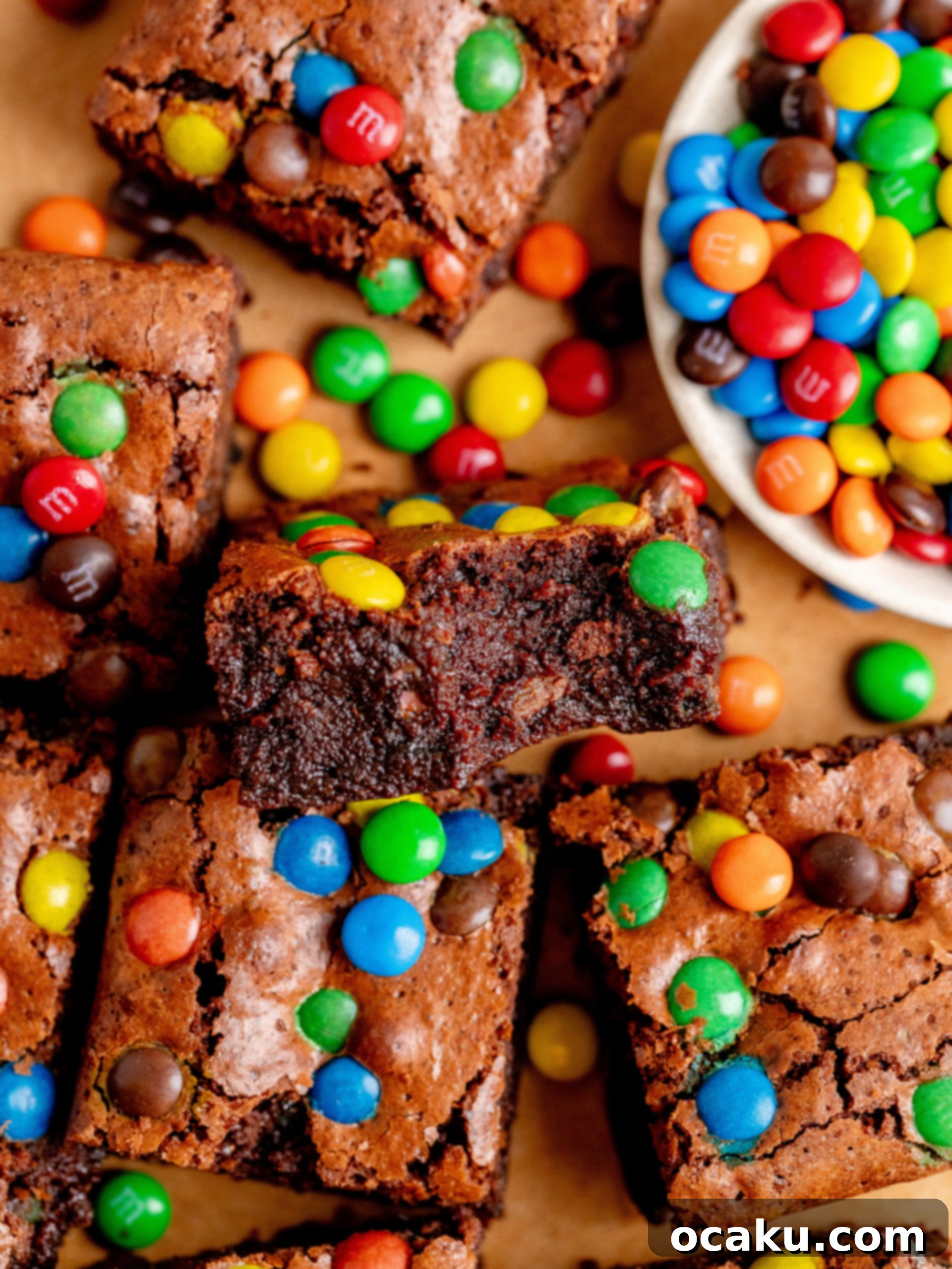 M&M Brownies 2 A perfectly sliced M&M brownie on a white plate, showcasing its fudgy interior and colorful candies.