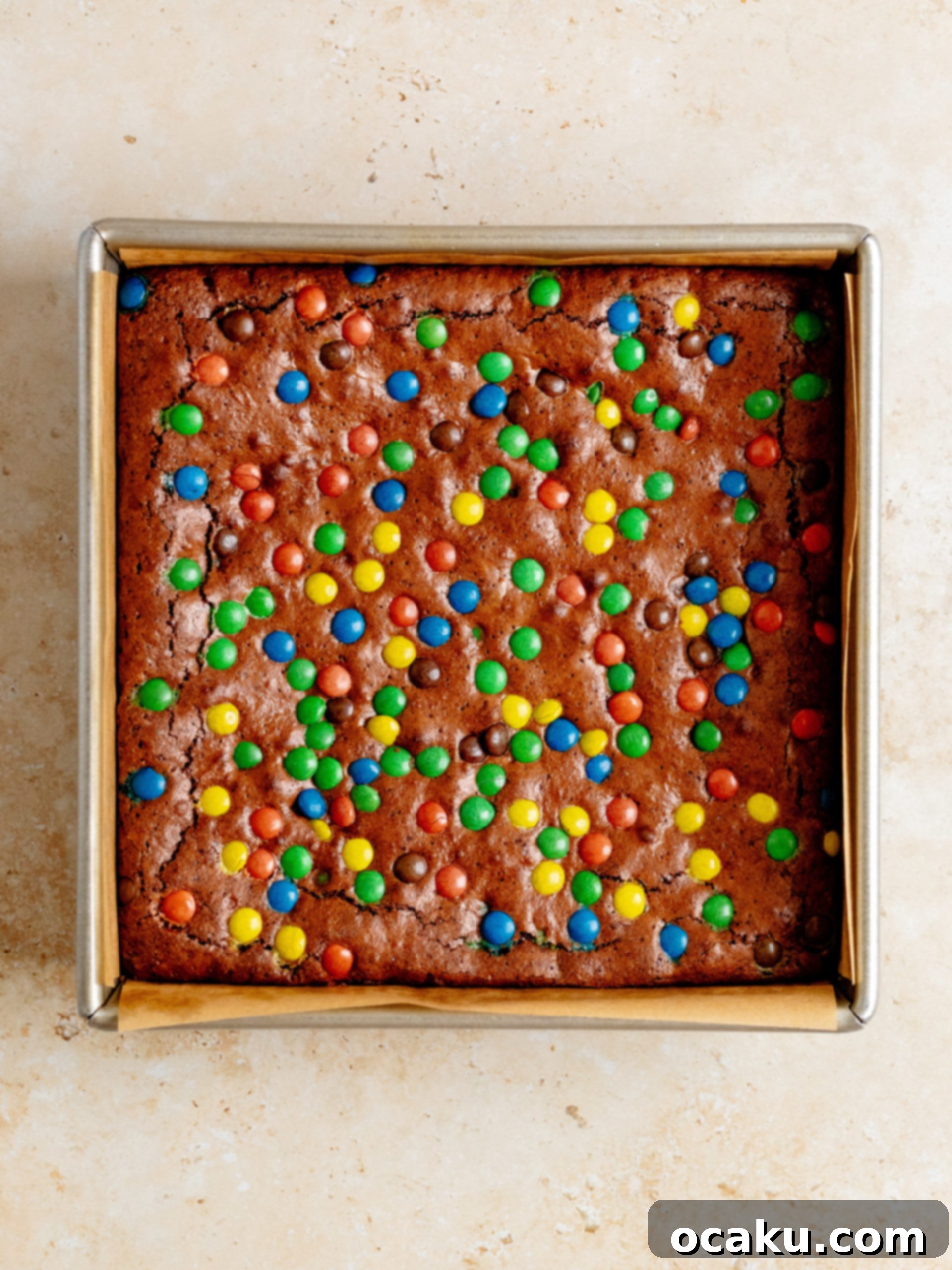 M&M Brownies 5 Melted butter and chocolate mixture in a bowl, ready for the next steps of brownie preparation.