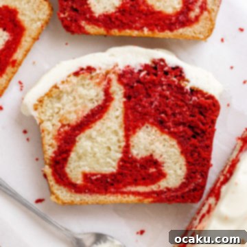A slice of Red Velvet Loaf Cake with cream cheese frosting.