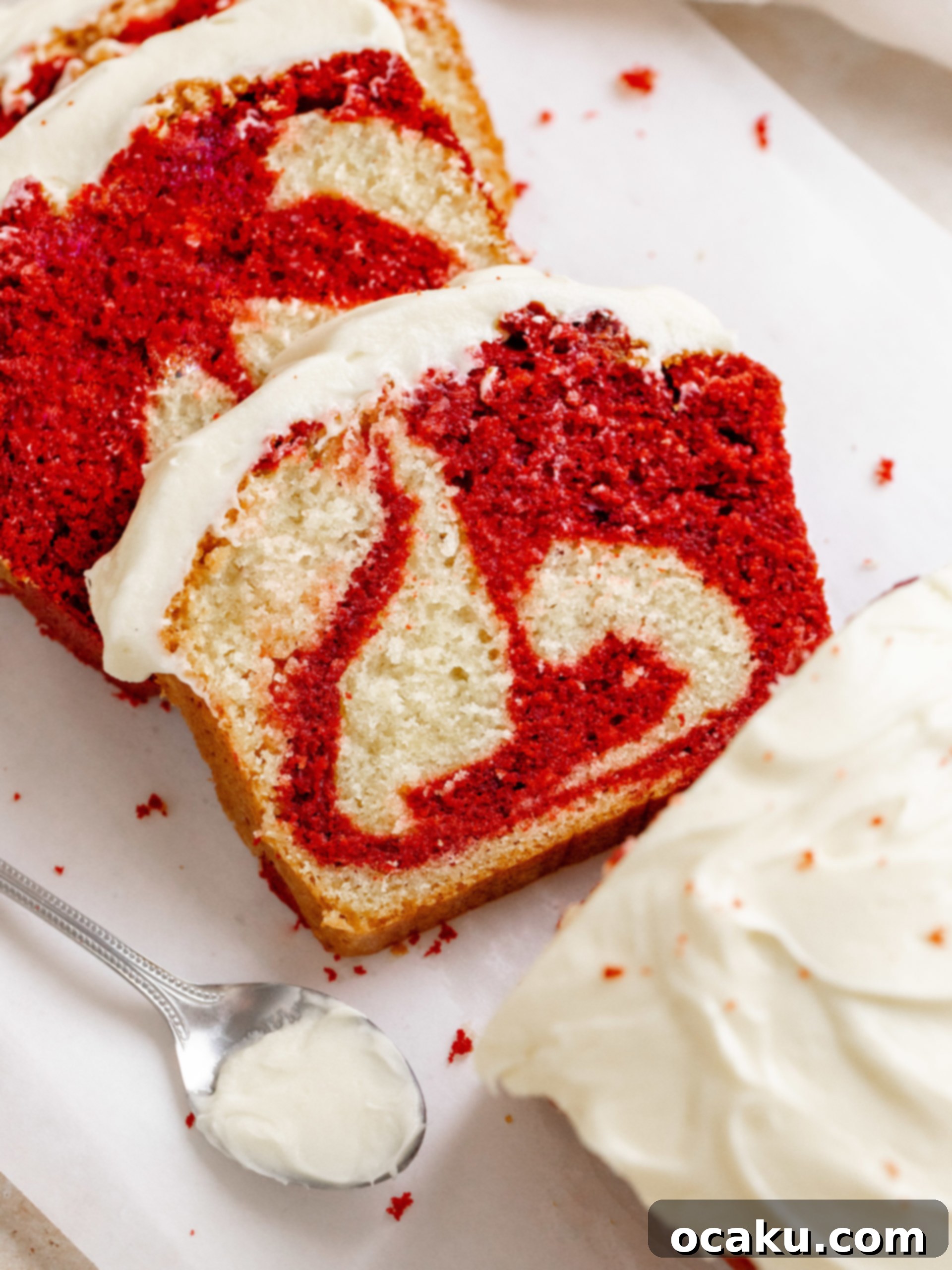Red velvet loaf cake with a generous layer of white cream cheese frosting.